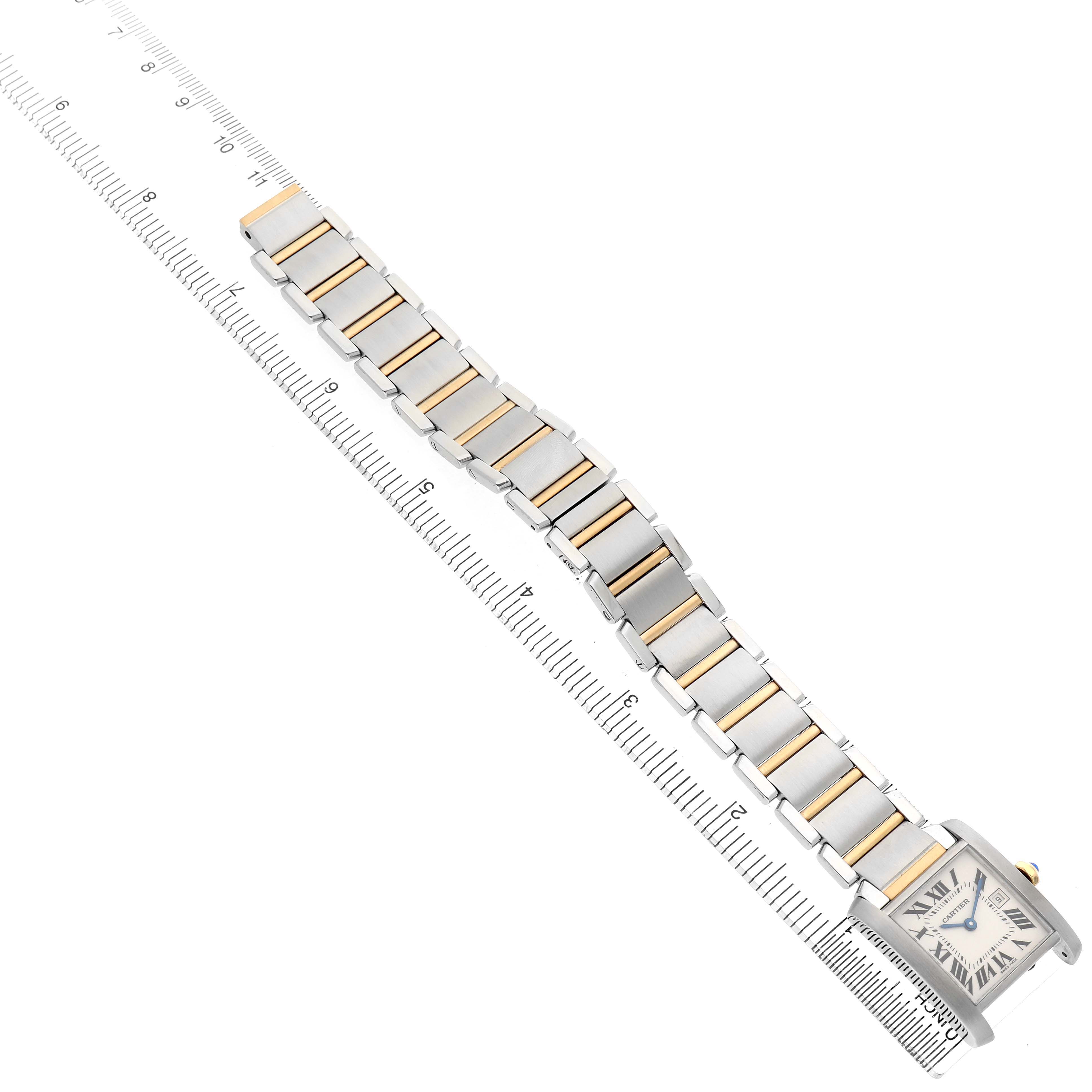 The Cartier Tank Francaise W51012Q4 Women's Steel and Gold (two tone) Silver Dial watch is shown at an angle, displaying its full bracelet and face alongside a ruler for measurement.