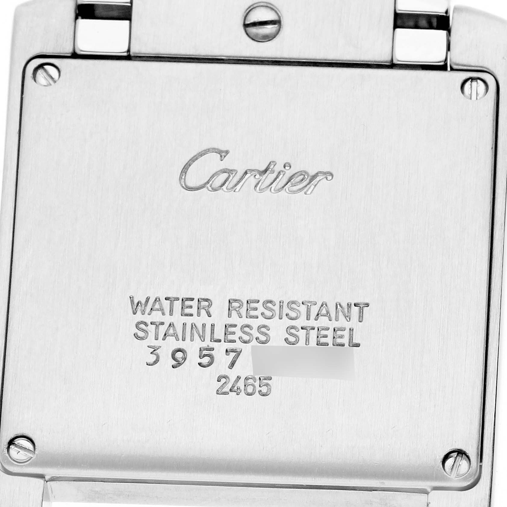 The image shows the back of a Cartier Tank Française watch with engravings visible.