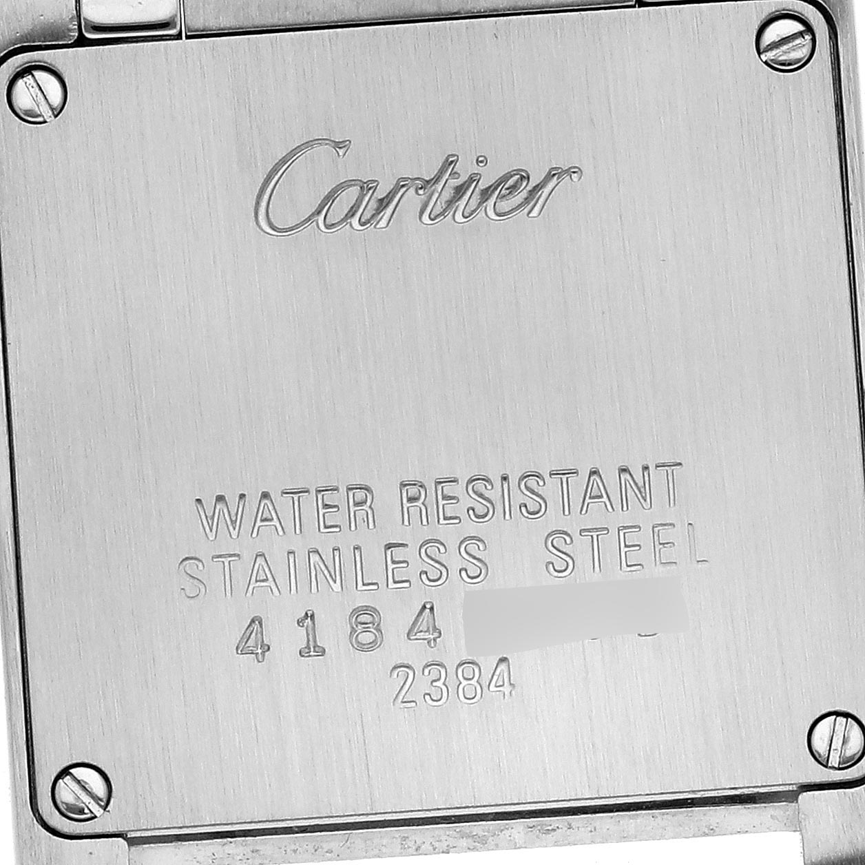 The image shows the back of a Cartier Tank Francaise W51007Q4 Women
s Steel and Gold (two tone) Silver Dial W51007Q4 Women
s Steel and Gold (two tone) Silver Dial watch, displaying engravings and four screws.