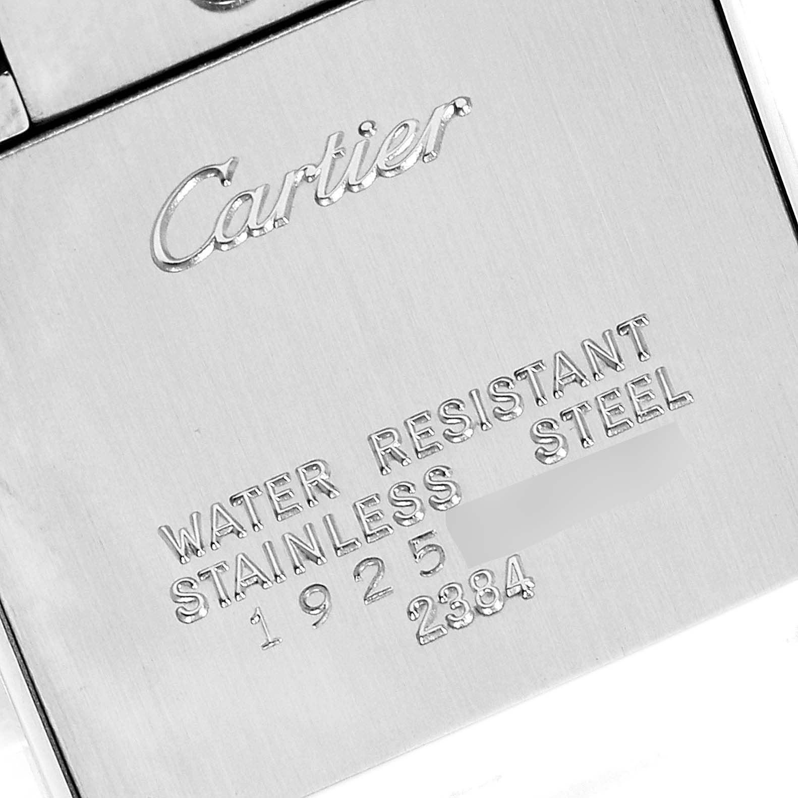 This is a close-up view of the back case of a Cartier Tank Francaise W51007Q4 Women's Steel and Gold (two tone) Silver Dial W51007Q4 Women's Steel and Gold (two tone) Silver Dial watch, showing the engraved brand name and specifications.
