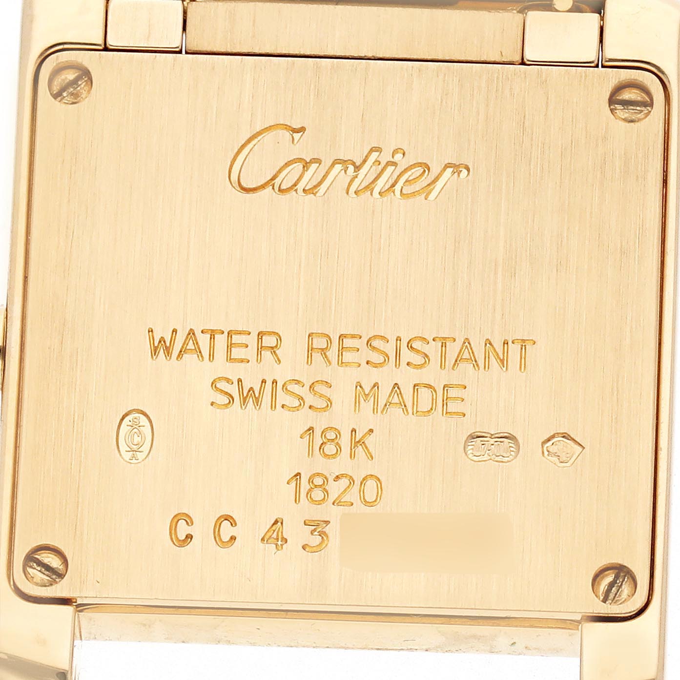 The image shows the back of a Cartier Tank Francaise W50002N2 Women
s Yellow Gold Silver Dial W50002N2 Women
s Yellow Gold Silver Dial watch, highlighting engravings and detailing.