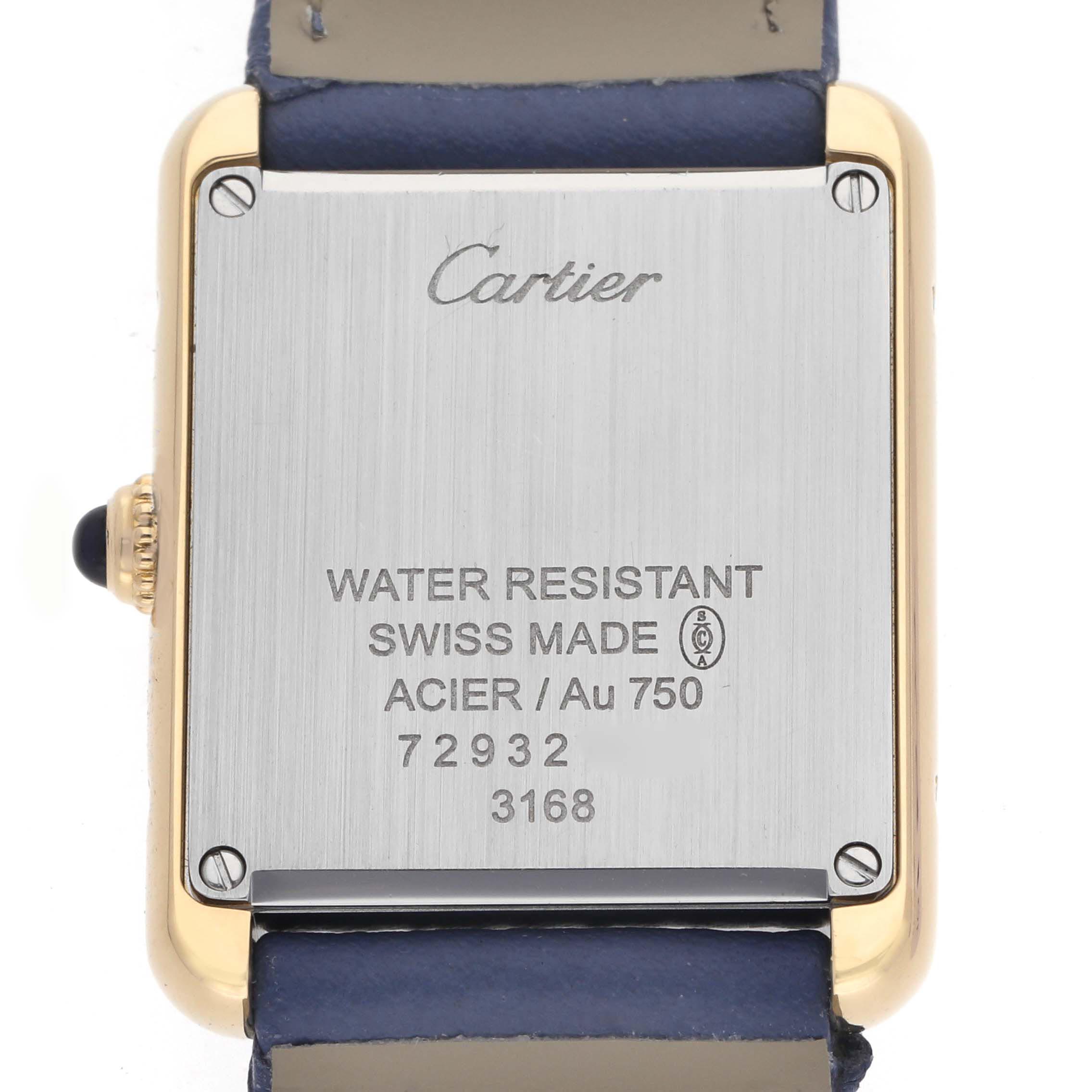 The image shows the back of a Cartier Tank Solo W5200002 Women
s Steel and Gold (two tone) Silver Dial W5200002 Women
s Steel and Gold (two tone) Silver Dial watch, featuring metal casing and engraved details.
