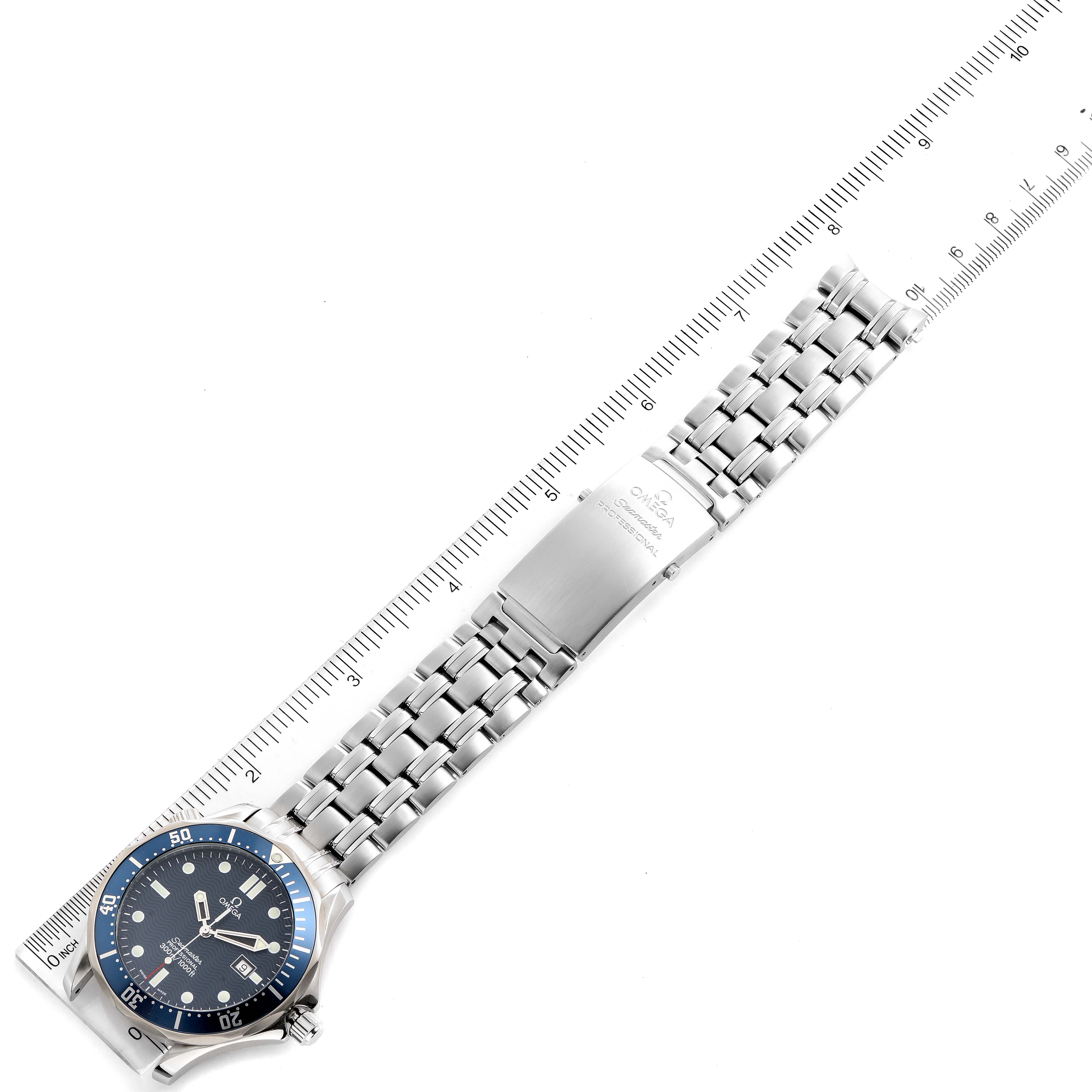 The image shows an Omega Seamaster 2541.80.00 Men
s Stainless Steel Blue Dial 2541.80.00 Men
s Stainless Steel Blue Dial watch laid flat beside a ruler, highlighting the face and metal bracelet.