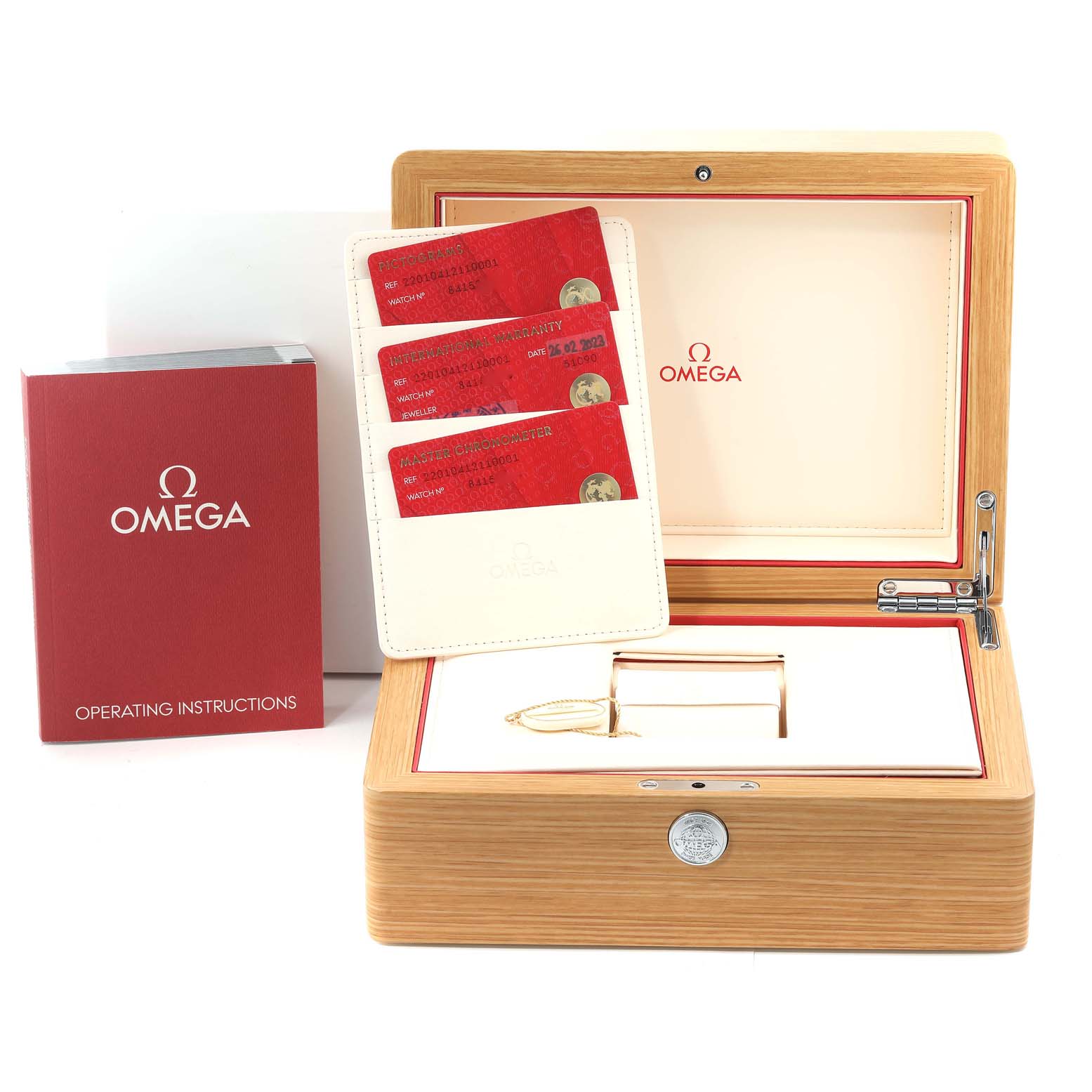 The image shows a wooden Omega Aqua Terra 220.10.41.21.10.001 Men's Stainless Steel Green Dial 220.10.41.21.10.001 Men's Stainless Steel Green Dial watch box, warranty cards, and an operating instructions booklet.