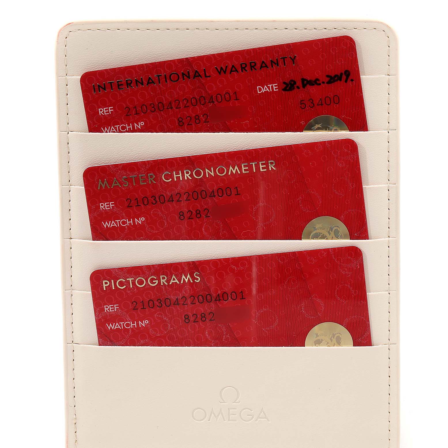 The image shows warranty and chronometer cards in a holder for the Omega Seamaster 210.30.42.20.04.001 Men
s Stainless Steel White Dial 210.30.42.20.04.001 Men
s Stainless Steel White Dial model.