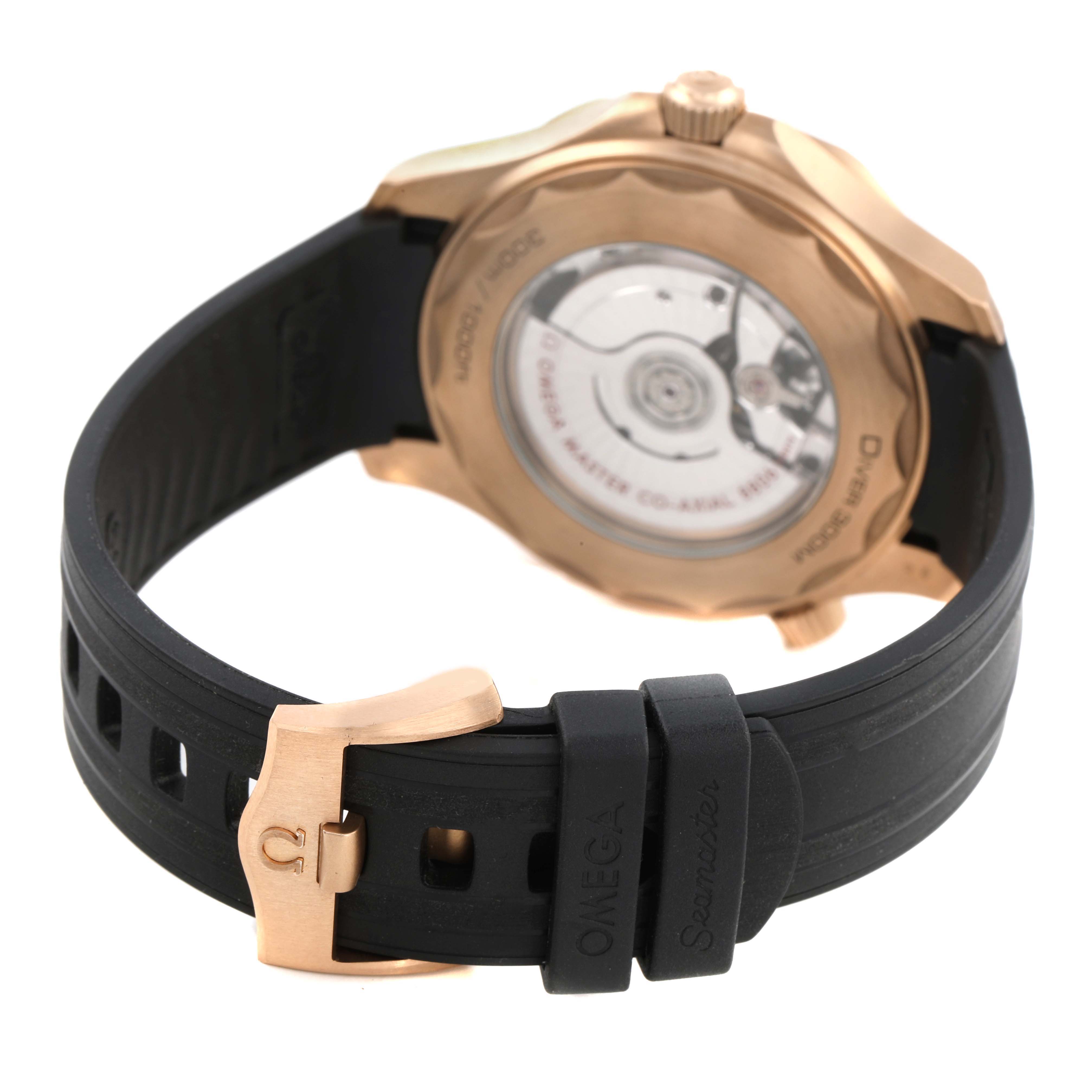 The Omega Seamaster 210.92.42.20.01.003 Men's Rose Gold Black Dial watch is shown from the back, highlighting the case back, movement, crown, and rubber strap with a buckle.