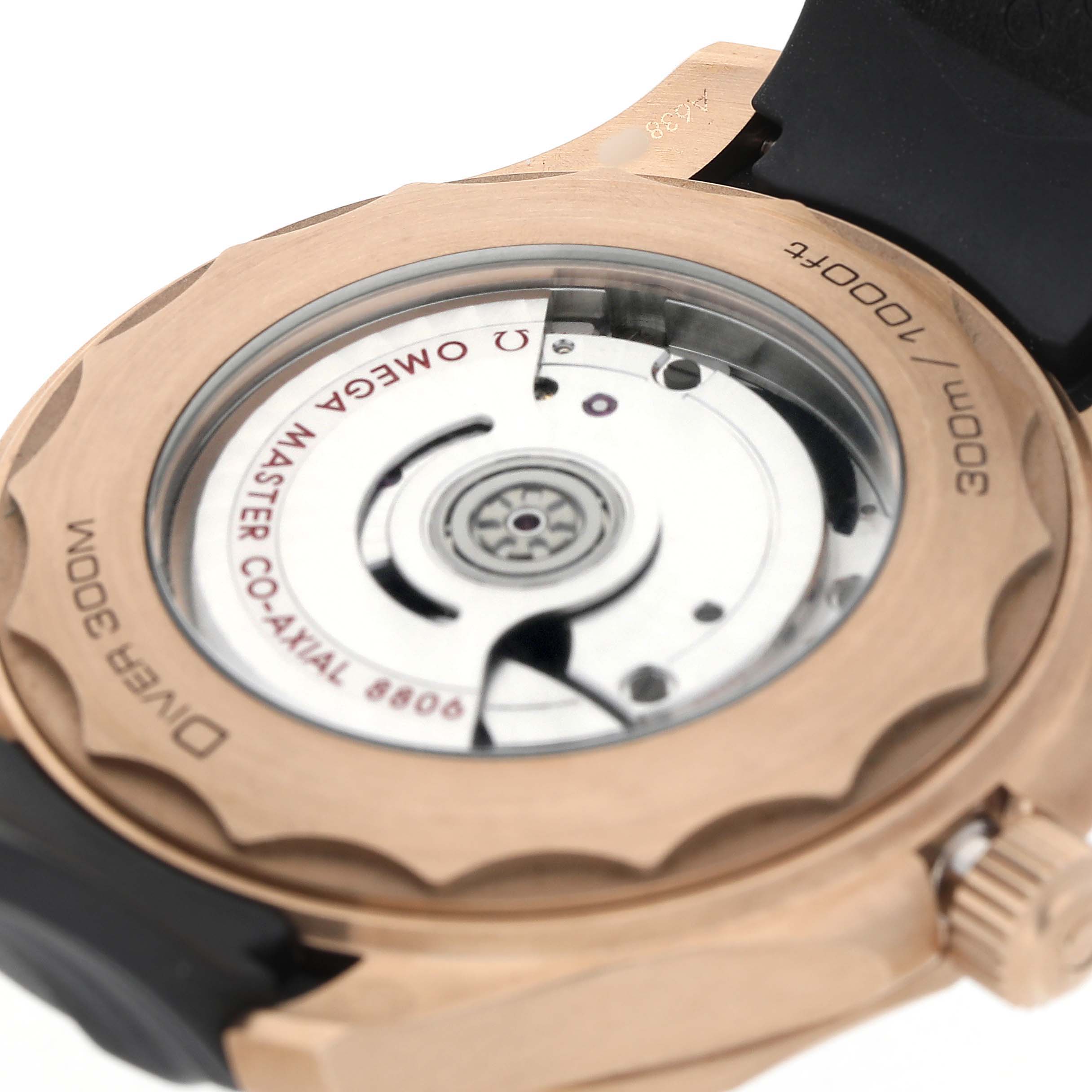The image shows the back of an Omega Seamaster 210.92.42.20.01.003 Men's Rose Gold Black Dial watch, highlighting the movement through the transparent case back.