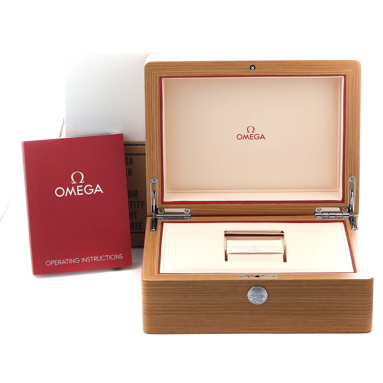 The image shows an open wood Omega box for the Seamaster model from a front angle, along with a red operating instructions booklet.