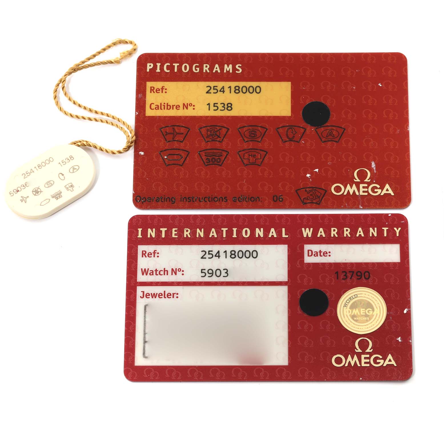 The image shows the pictogram and international warranty cards for the Omega Seamaster 2541.80.00 Men's Stainless Steel Blue Dial 2541.80.00 Men's Stainless Steel Blue Dial watch, along with a white tag.