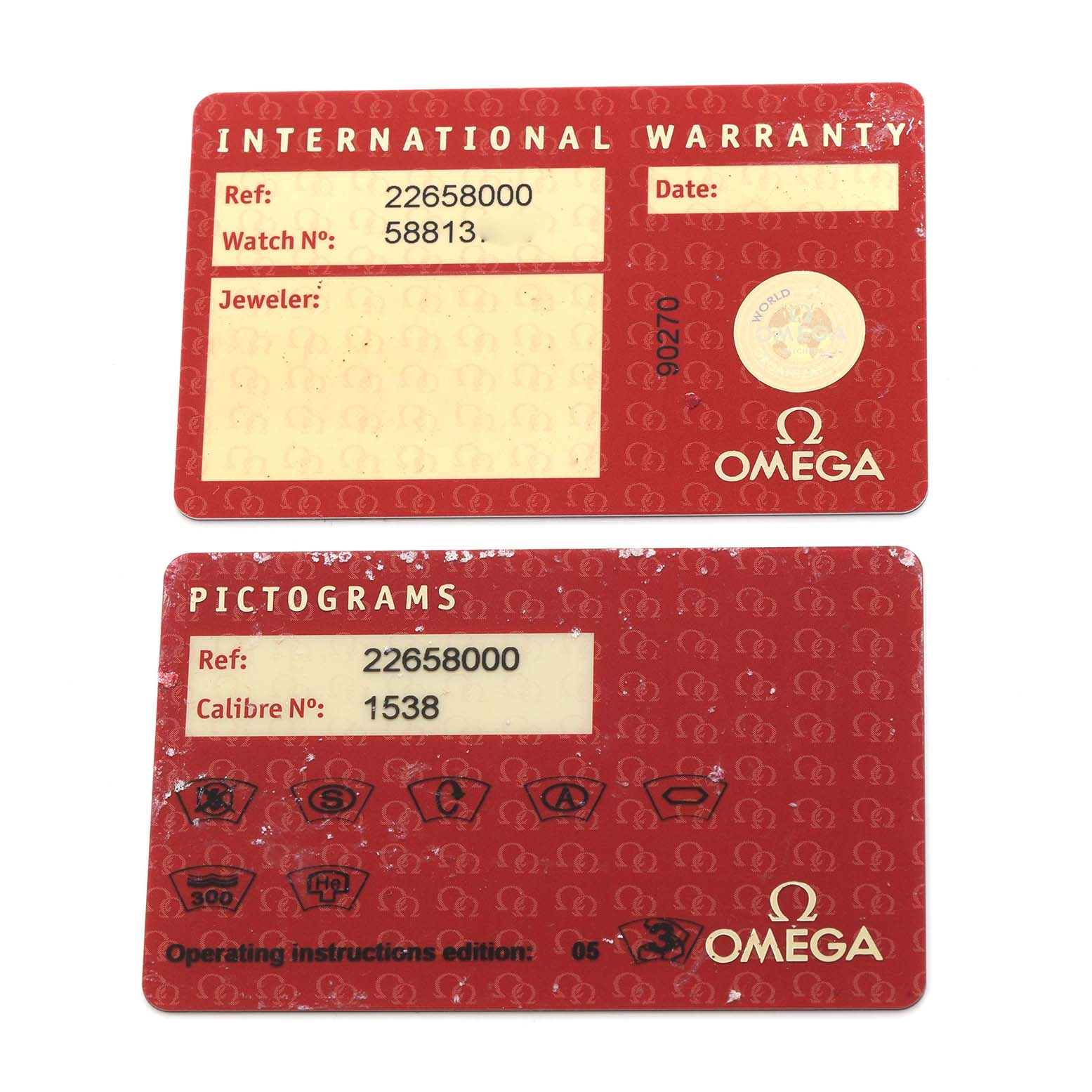 The image shows two Omega Seamaster 2265.80.00 Men
s Stainless Steel Blue Dial 2265.80.00 Men
s Stainless Steel Blue Dial cards: an International Warranty and a Pictograms card, both photographed from above.