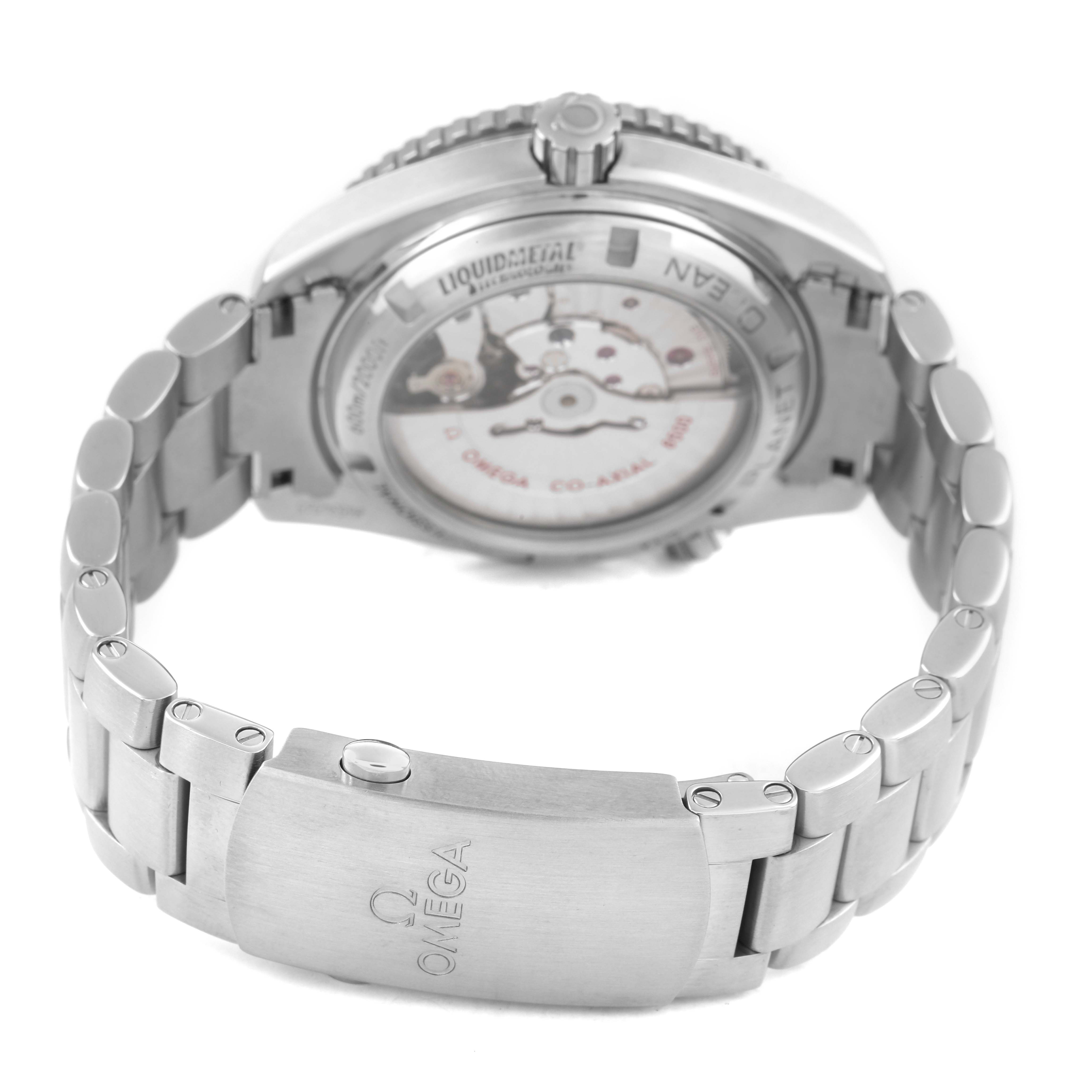 The image shows the back case and bracelet of the Omega Seamaster 232.90.42.21.03.001 Men's Titanium Blue Dial watch, highlighting its clasp and mechanical movement.