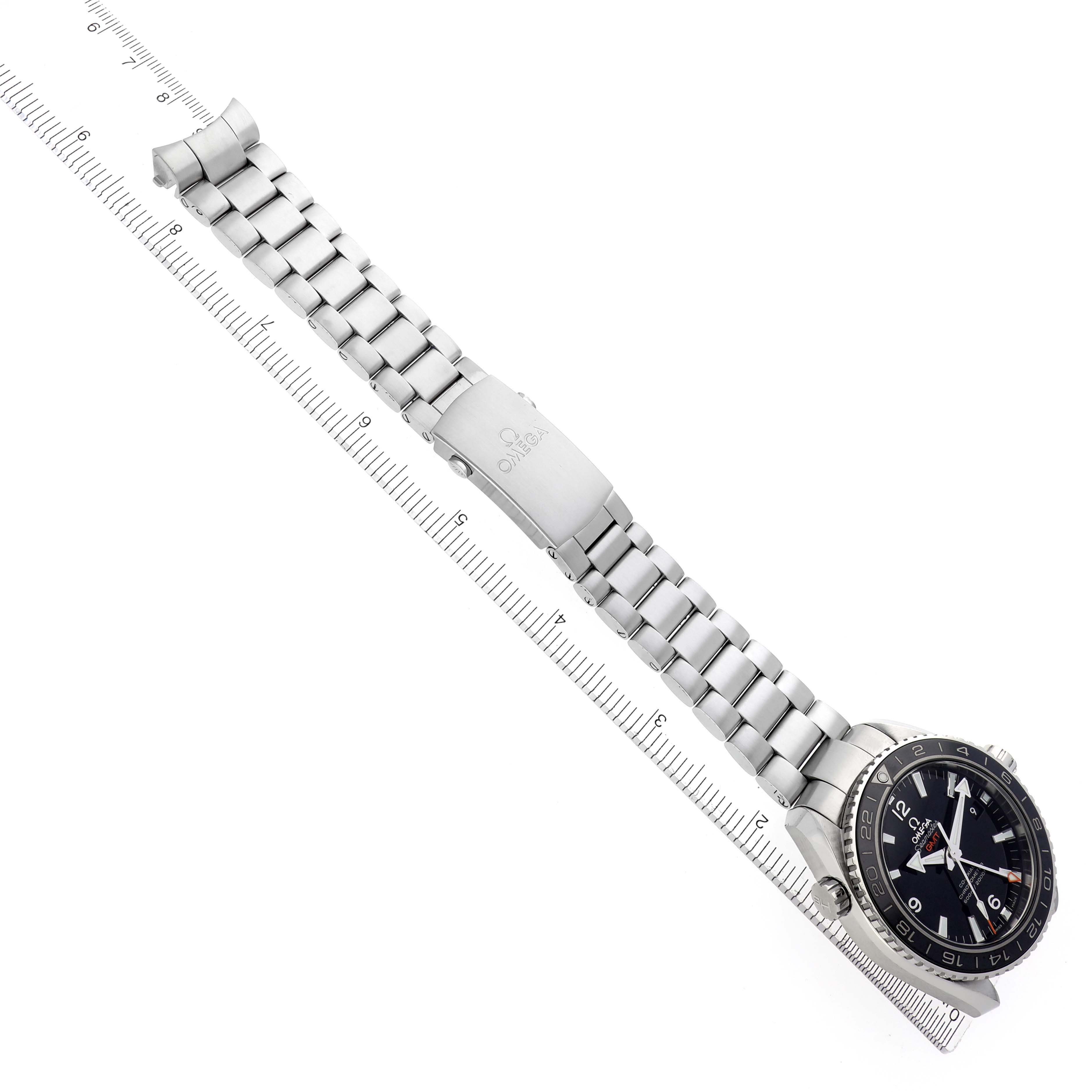 The Omega Planet Ocean 232.30.44.22.01.001 Men
s Stainless Steel Black Dial 232.30.44.22.01.001 Men
s Stainless Steel Black Dial watch is displayed at a slight angle, showing the bracelet, clasp, and face aligned with a measuring ruler.