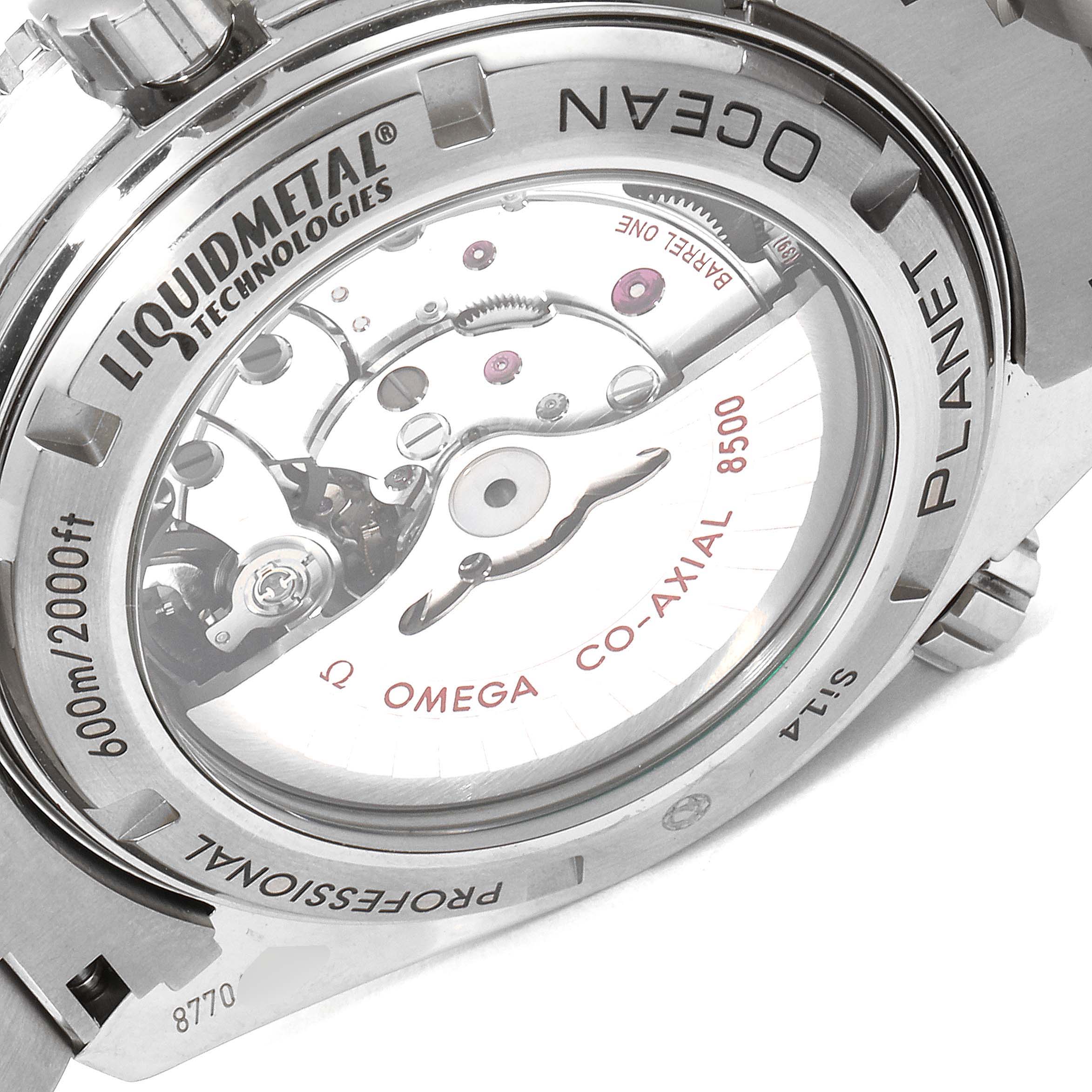 The photo shows the back view of the Omega Seamaster 232.90.46.21.03.001 Men's Titanium Blue Dial 232.90.46.21.03.001 Men's Titanium Blue Dial watch, revealing the inner mechanical movement with "OMEGA CO-AXIAL 8500" inscription.