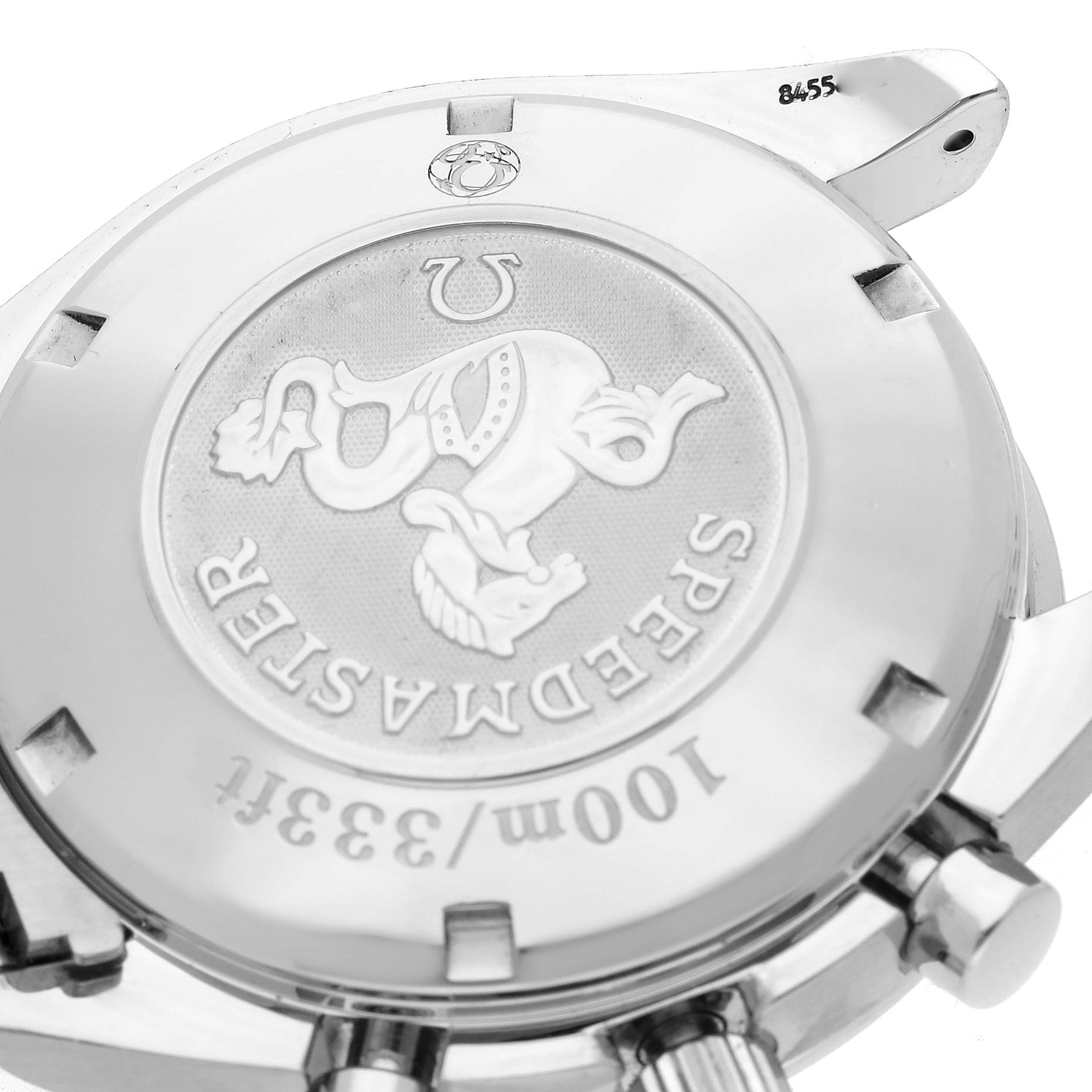 The image shows the case back of an Omega Speedmaster 3212.80.00 Men
s Stainless Steel Blue Dial 3212.80.00 Men
s Stainless Steel Blue Dial, highlighting the emblem and engravings.