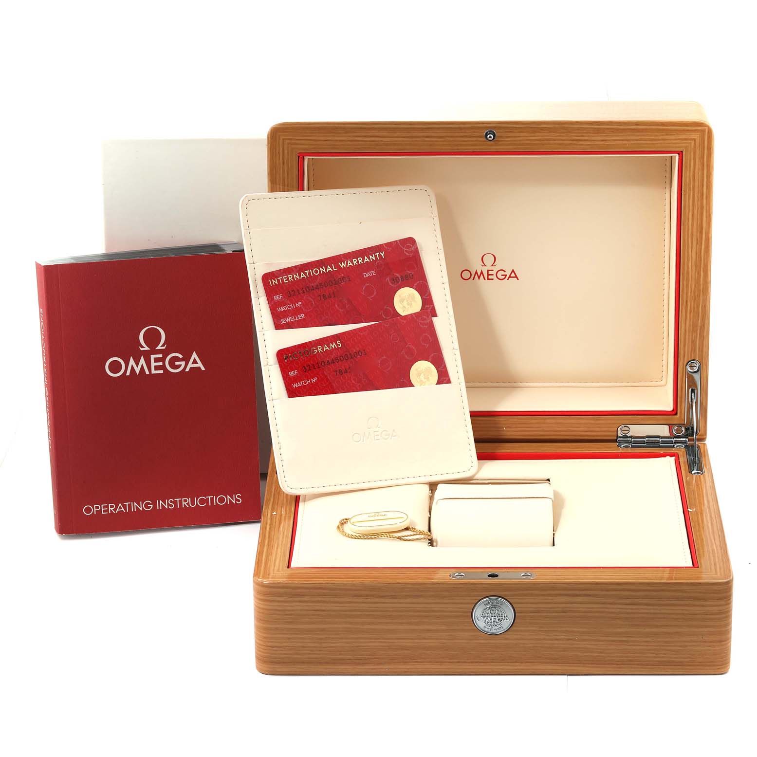 The image shows an Omega Speedmaster 321.10.44.50.01.001 Men
s Stainless Steel Black Dial 321.10.44.50.01.001 Men
s Stainless Steel Black Dial watch box, warranty cards, operation instructions booklet, and accessories from a front angle.