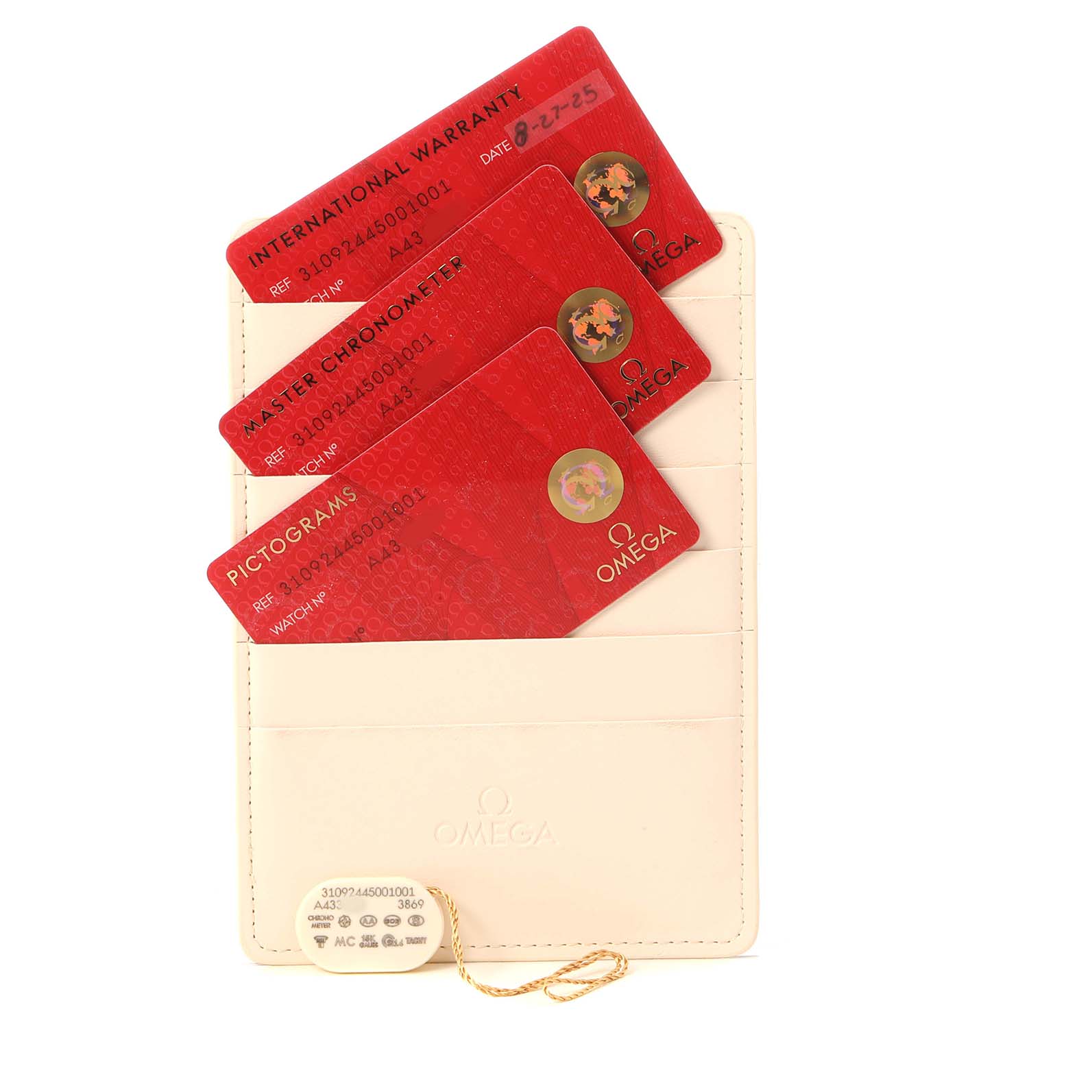 The image shows Omega Speedmaster 310.92.44.50.01.001 Men's Ceramic Black Dial accessories, including red cards for warranty and certification in a cream-colored holder.