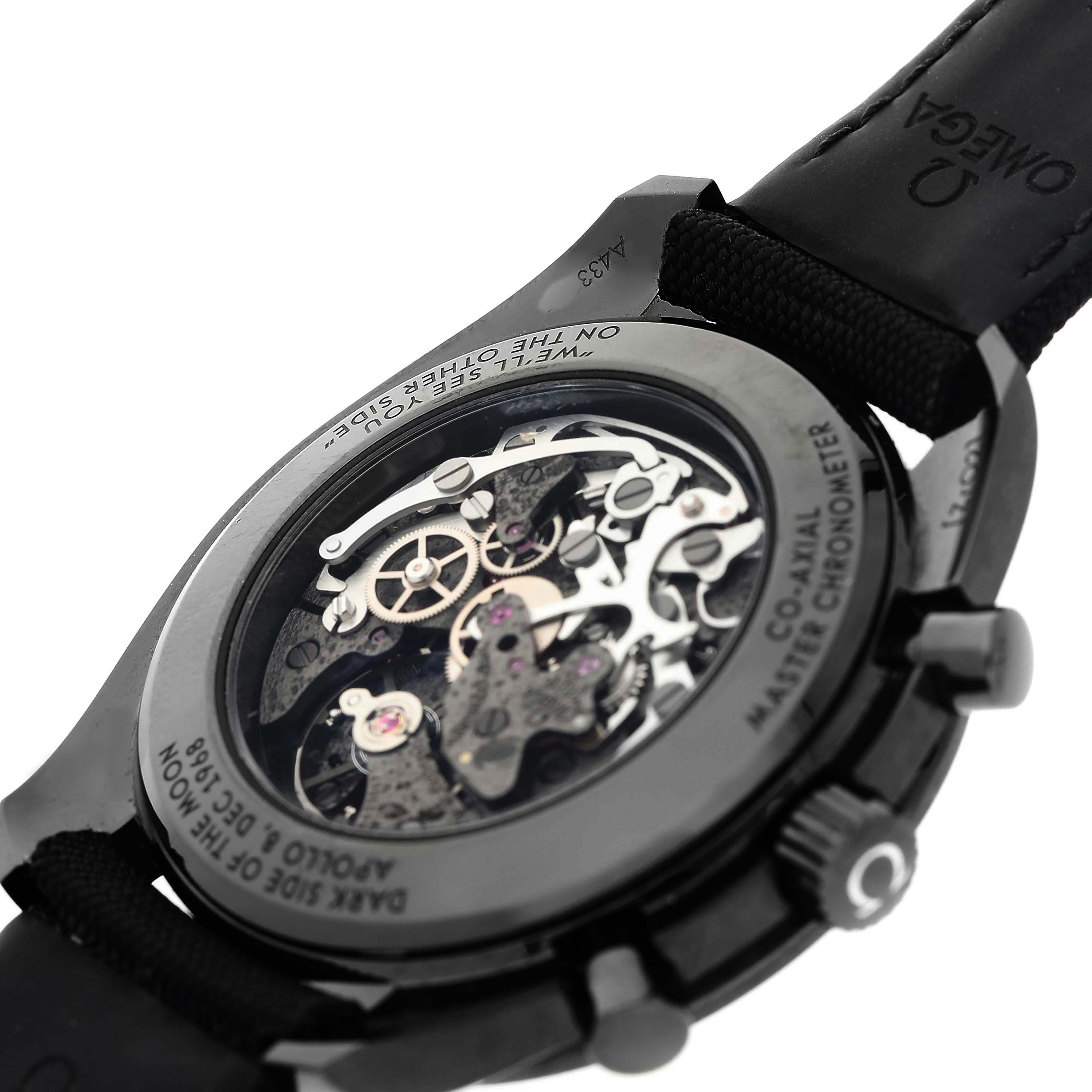 The image shows the back view of an Omega Speedmaster 310.92.44.50.01.001 Men's Ceramic Black Dial, highlighting its exposed mechanical movements inside the case.
