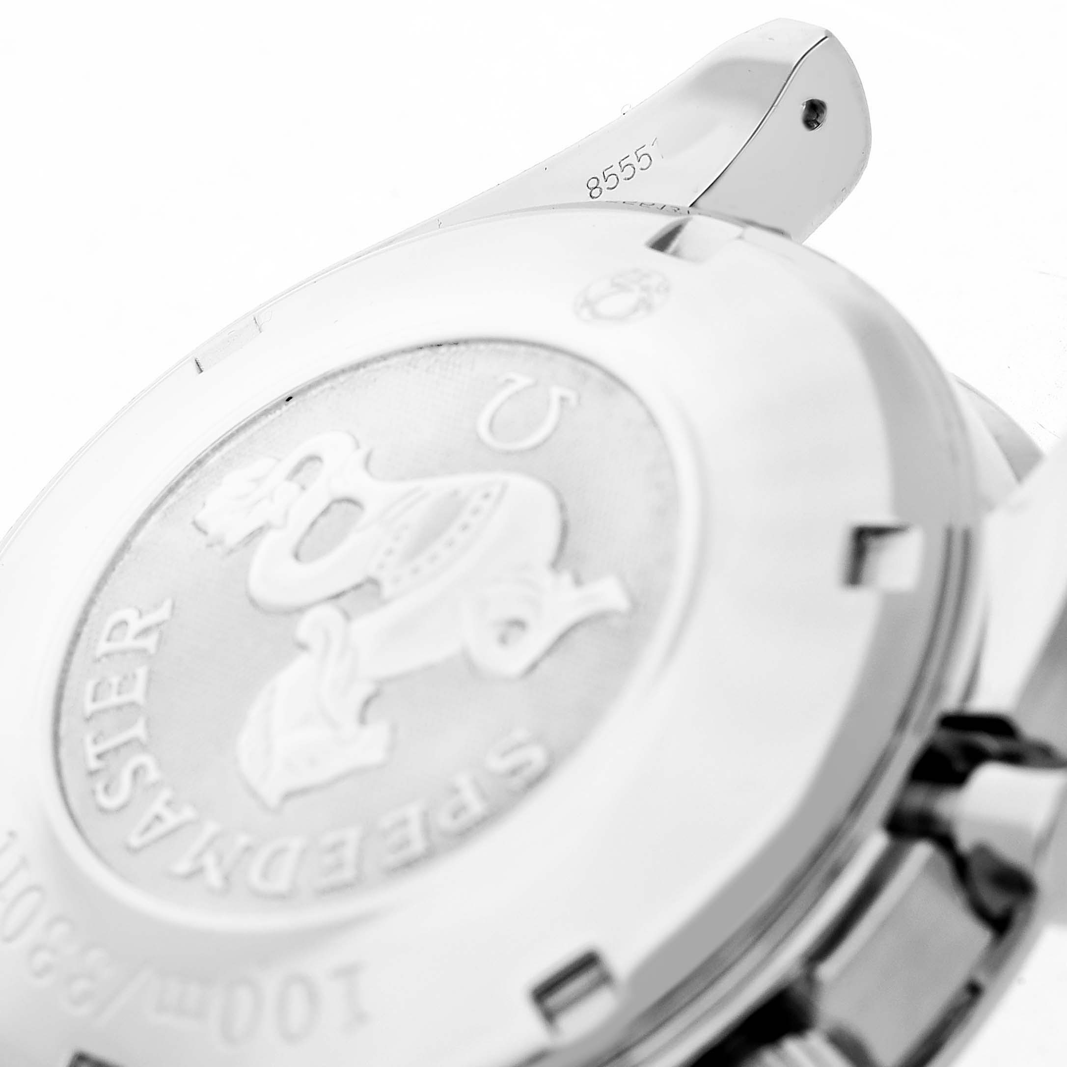 The image shows the back case of an Omega Speedmaster 3211.31.00 Men's Stainless Steel Silver Dial, featuring its emblem and some engraved details.