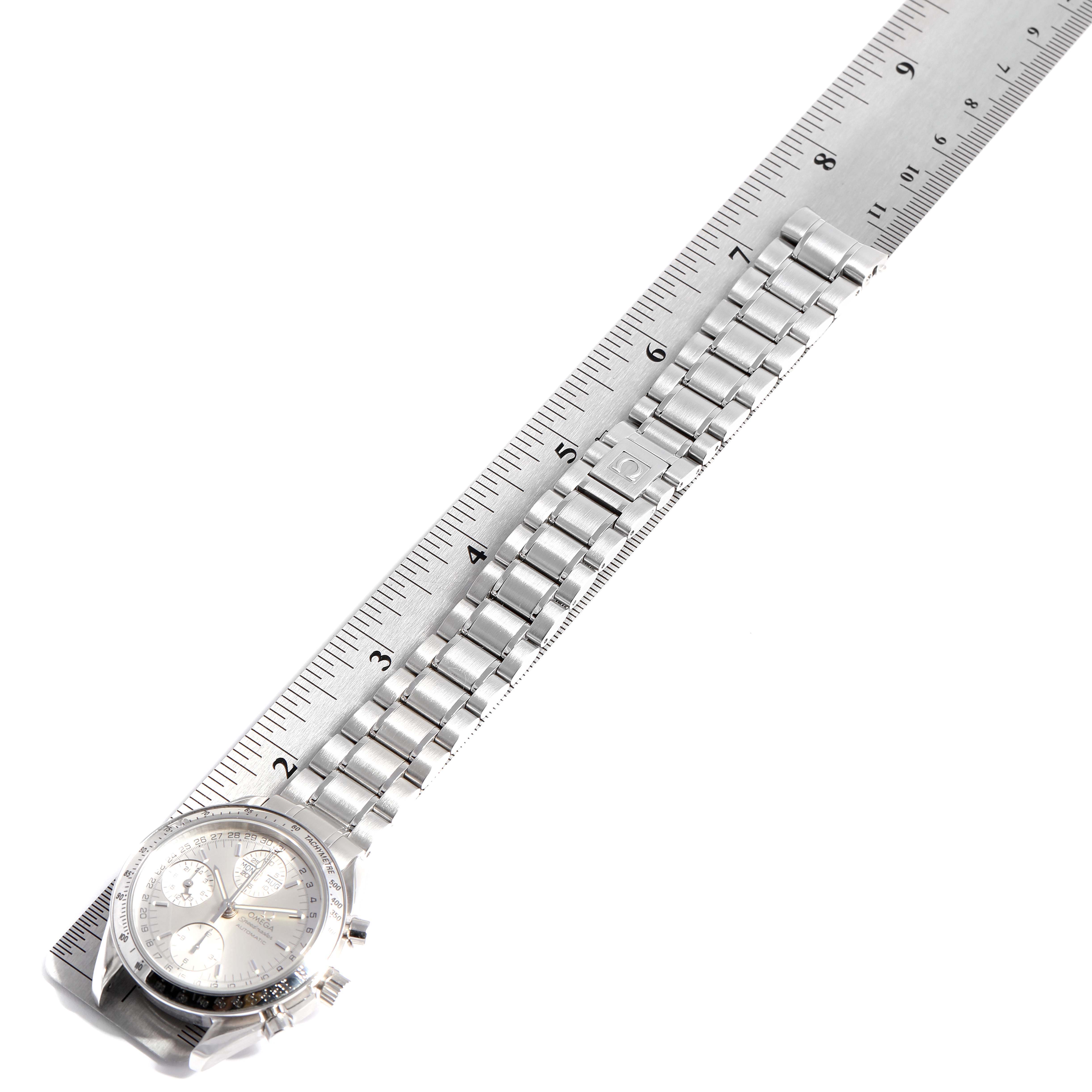 The image shows an Omega Speedmaster 3523.30.00 Men
s Stainless Steel Silver Dial 3523.30.00 Men
s Stainless Steel Silver Dial watch laid flat with its stainless steel bracelet against a ruler for scale.