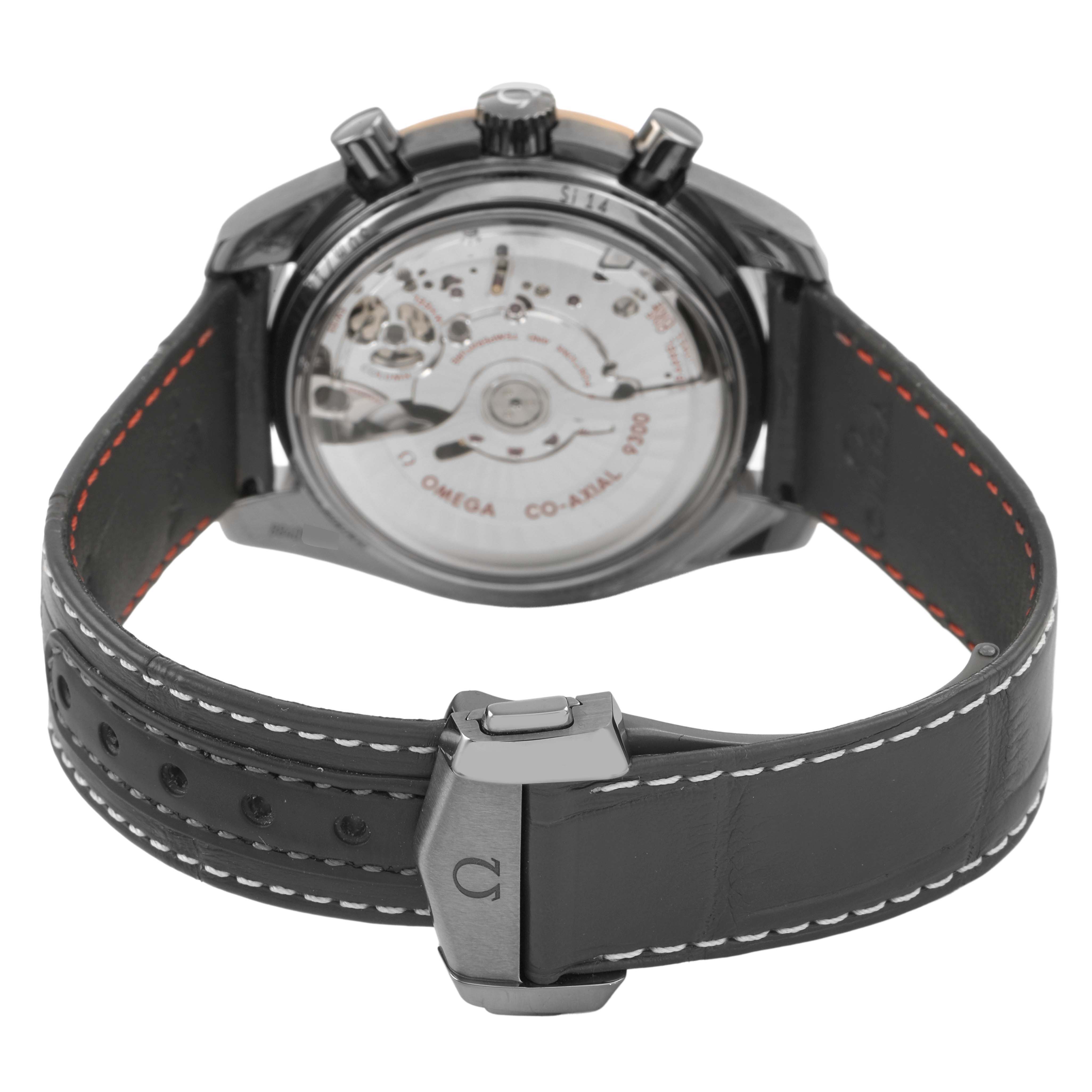 The image shows the back of the Omega Speedmaster 311.63.44.51.99.001 Men's Ceramic Grey Dial, highlighting the visible movement and leather strap with clasp.