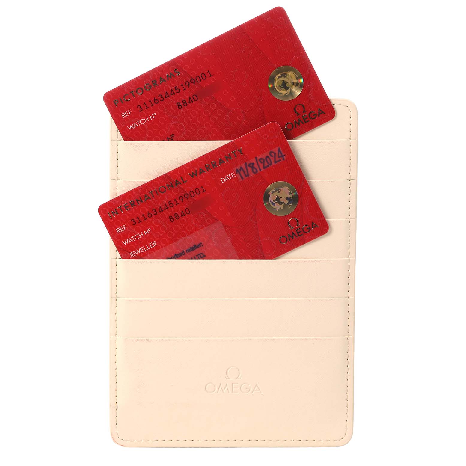 The image shows two red cards in a beige Omega cardholder for a Speedmaster model, displaying warranty and pictogram details.