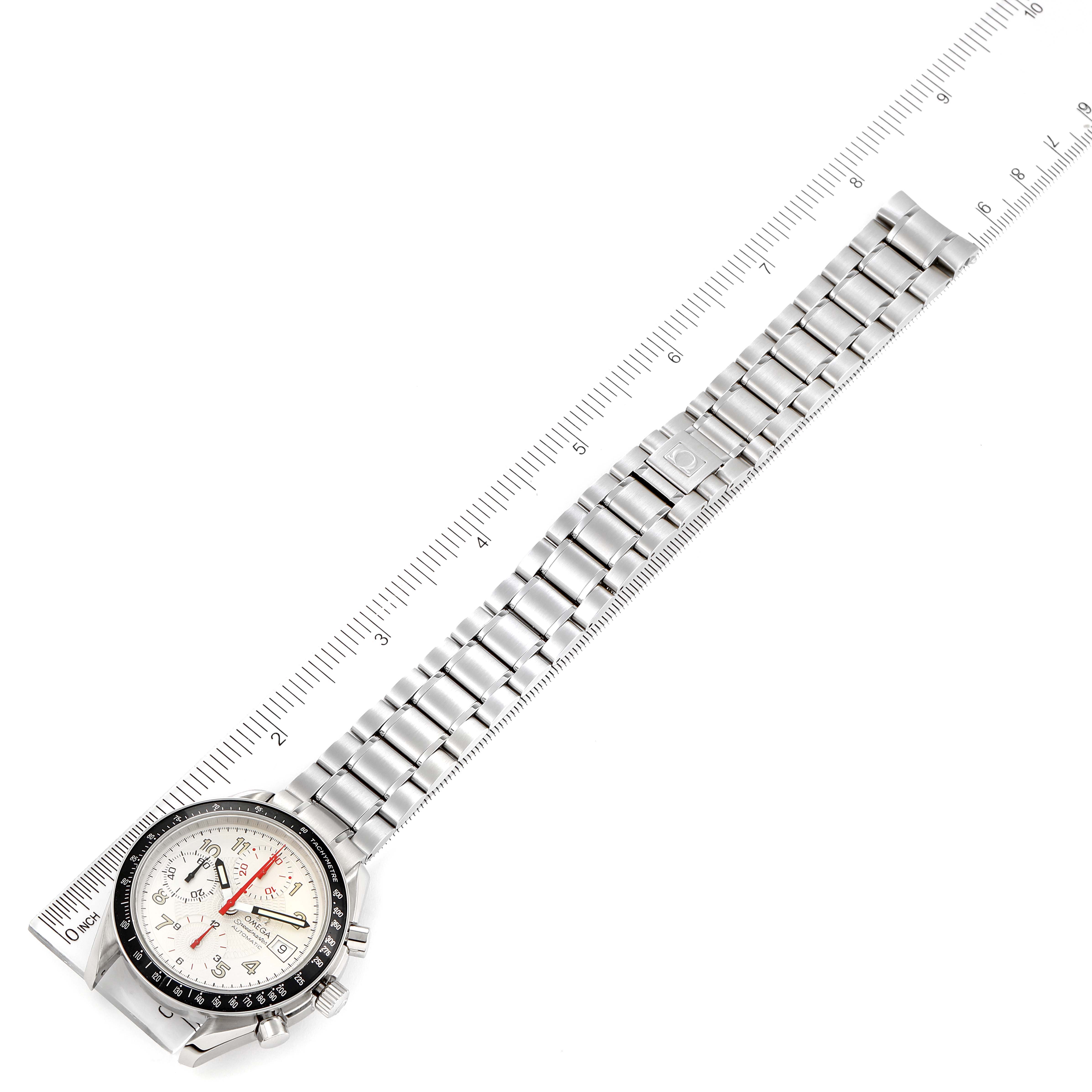 The image shows an Omega Speedmaster 3513.33.00 Men's Stainless Steel White Dial 3513.33.00 Men's Stainless Steel White Dial watch photographed at a diagonal angle, highlighting its face and metal bracelet alongside a ruler.
