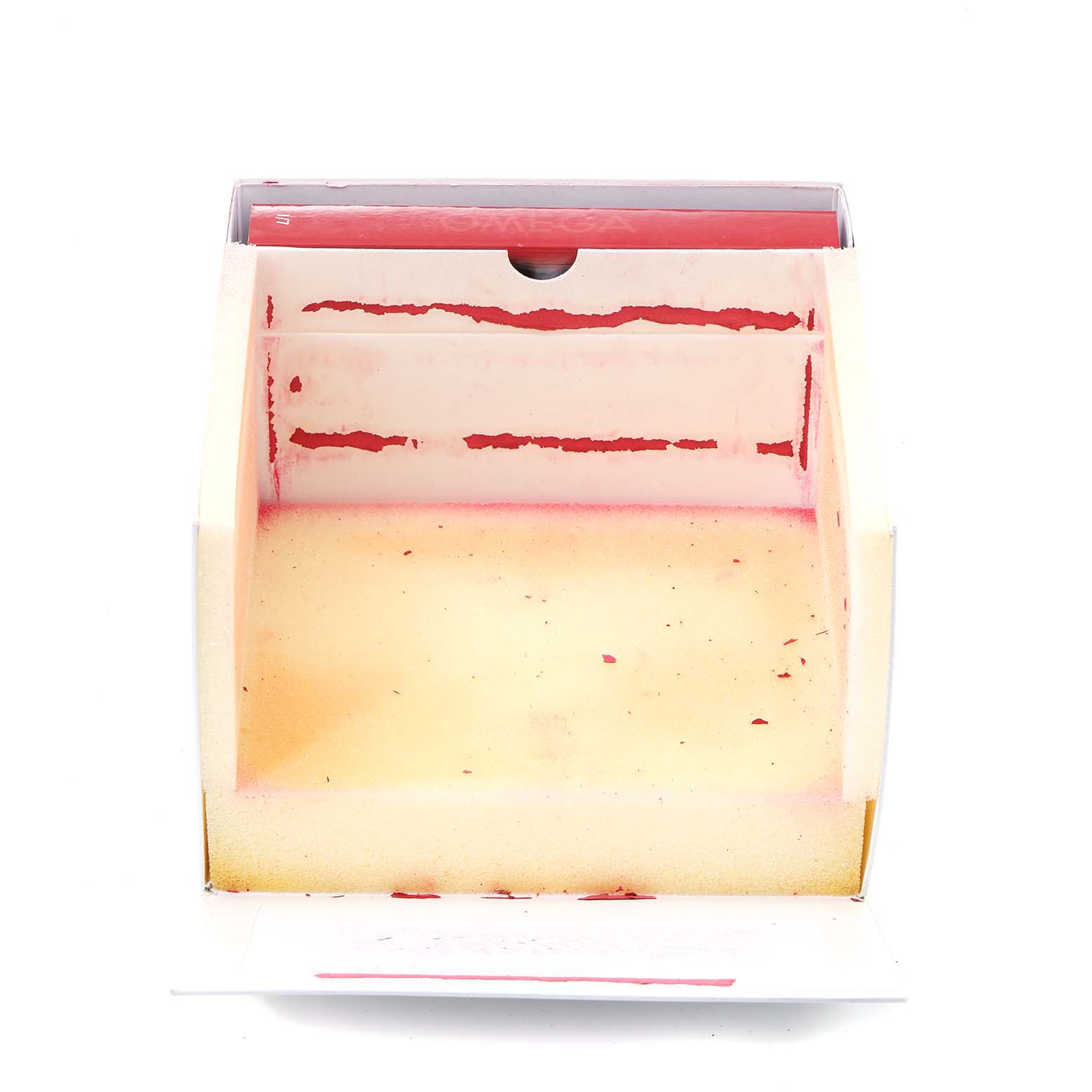 This image shows the inside of an Omega Speedmaster 3577.50.00 Men's Stainless Steel Black Dial 3577.50.00 Men's Stainless Steel Black Dial watch box from a top-down angle.