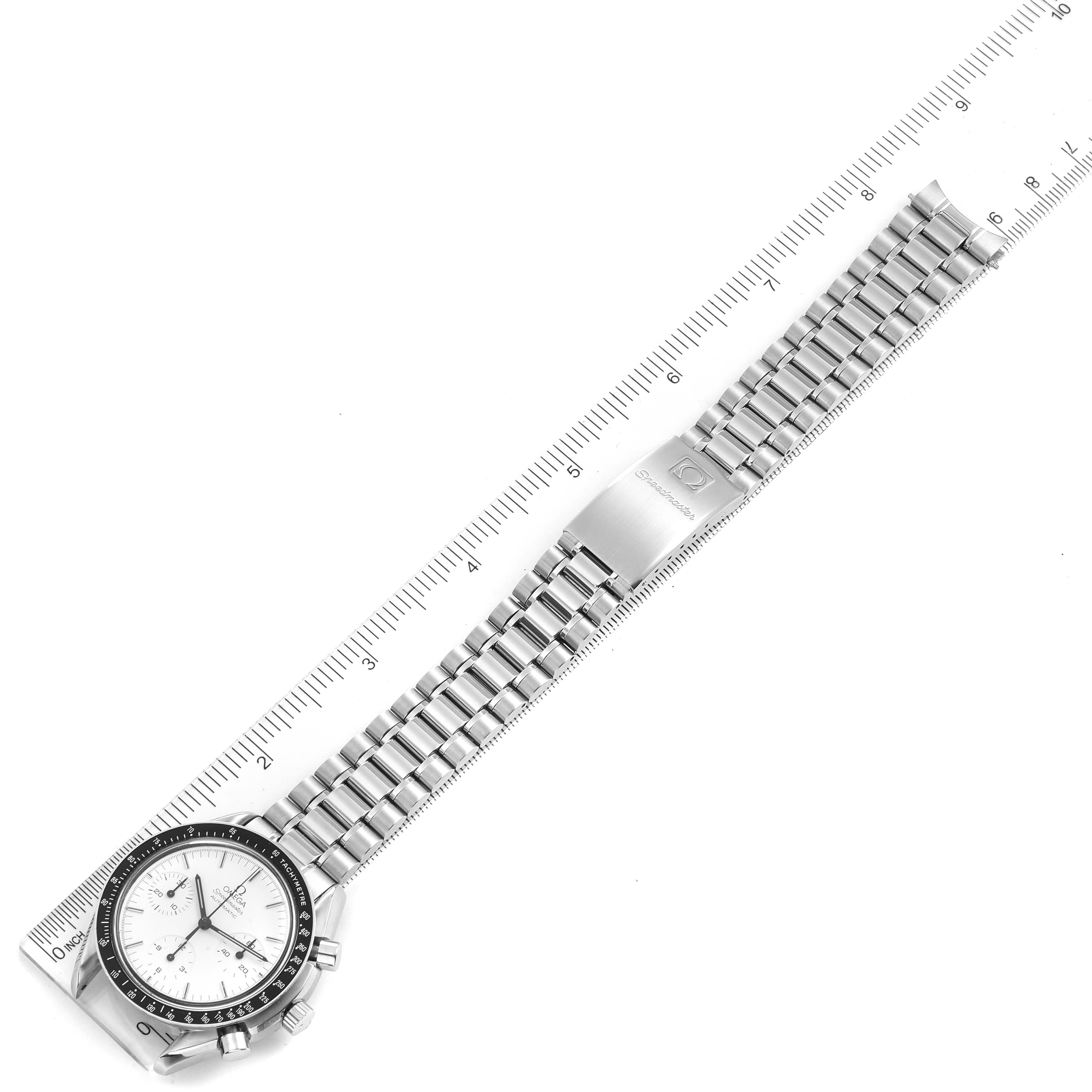 This image shows the Omega Speedmaster 3510.20.00 Men
s Stainless Steel White Dial 3510.20.00 Men
s Stainless Steel White Dial watch from a top-down angle, displaying the full bracelet and dial with a ruler for scale.