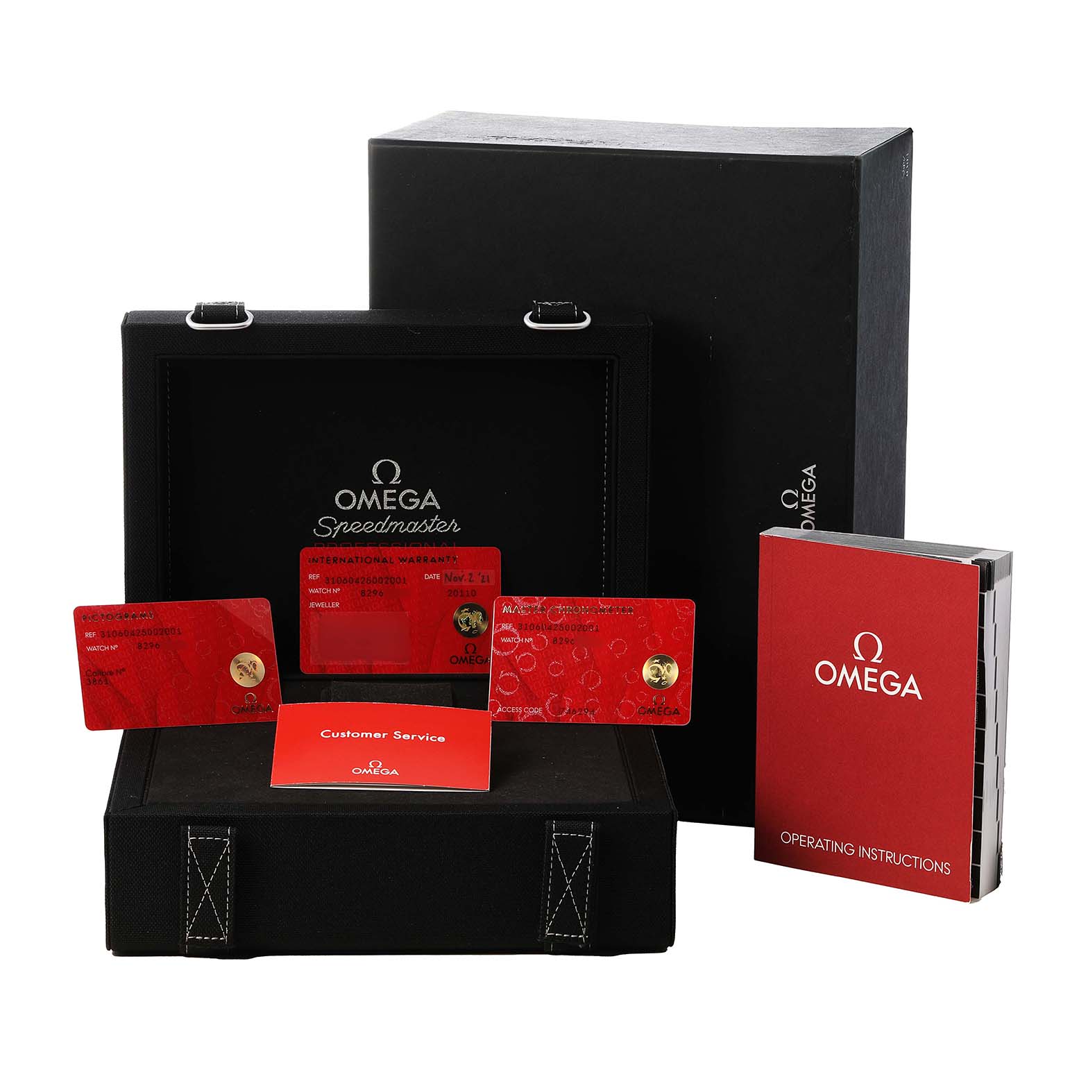 The image shows the packaging and accessories for an Omega Speedmaster 310.60.42.50.02.001 Men's White Gold Silver Dial, including a box, warranty cards, and manuals.