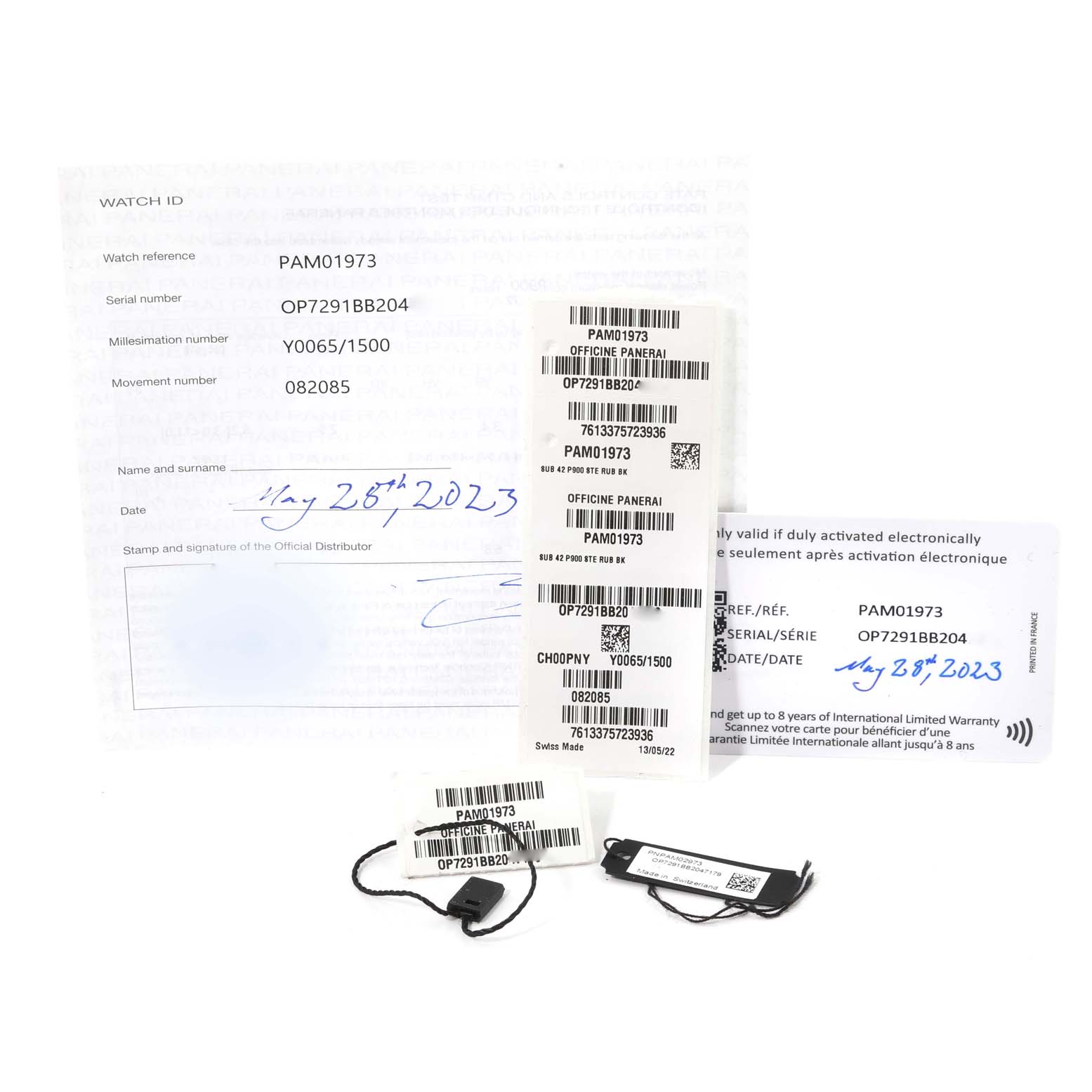 The image shows the warranty card, tags, and documentation for the Panerai Submersible PAM01973 Men's Stainless Steel Black Dial PAM01973 Men's Stainless Steel Black Dial model PAM01973.