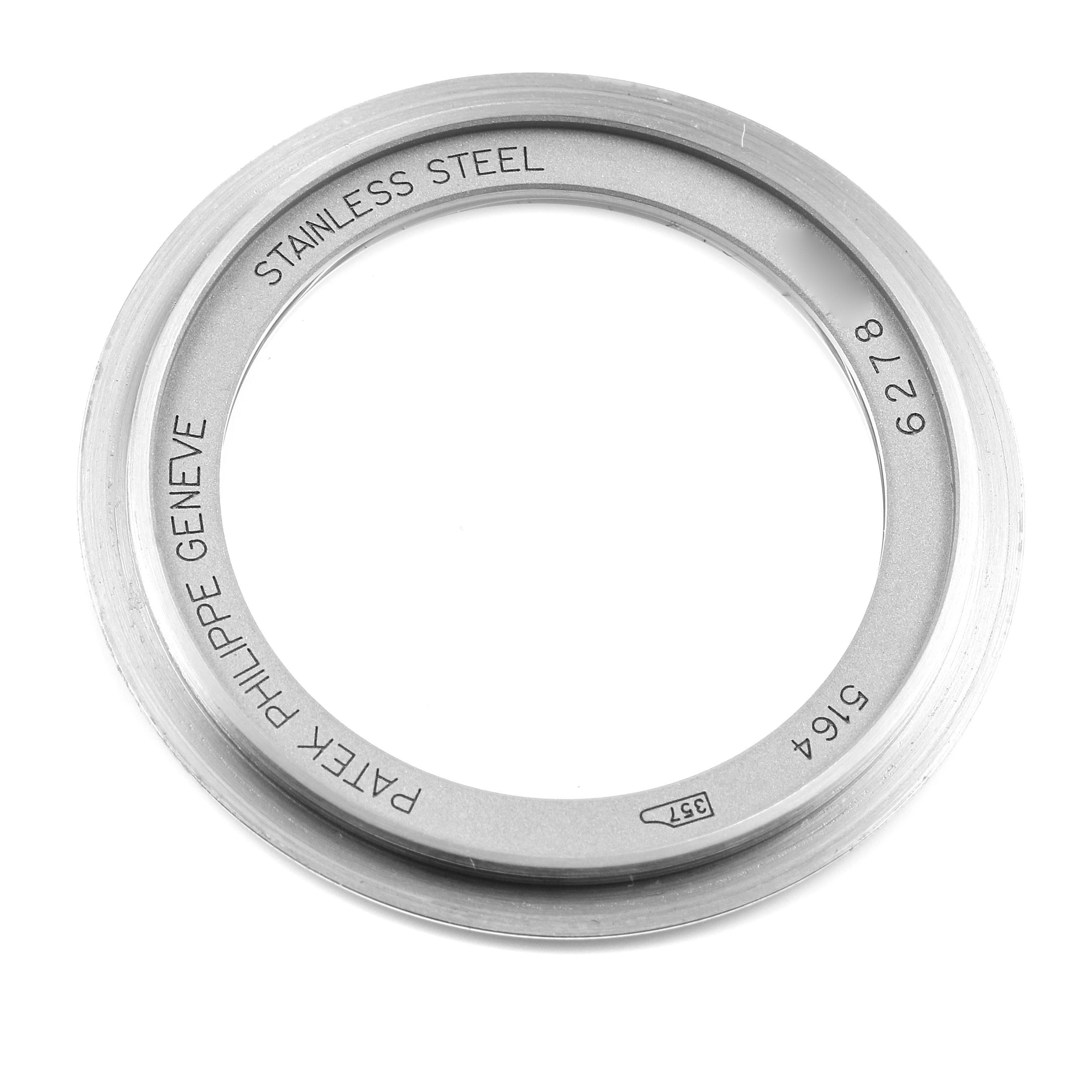 This is a close-up image of a stainless steel ring component for a Patek Philippe Aquanaut 5164A Men's Stainless Steel Black Dial 5164A Men's Stainless Steel Black Dial watch, featuring engraved text.