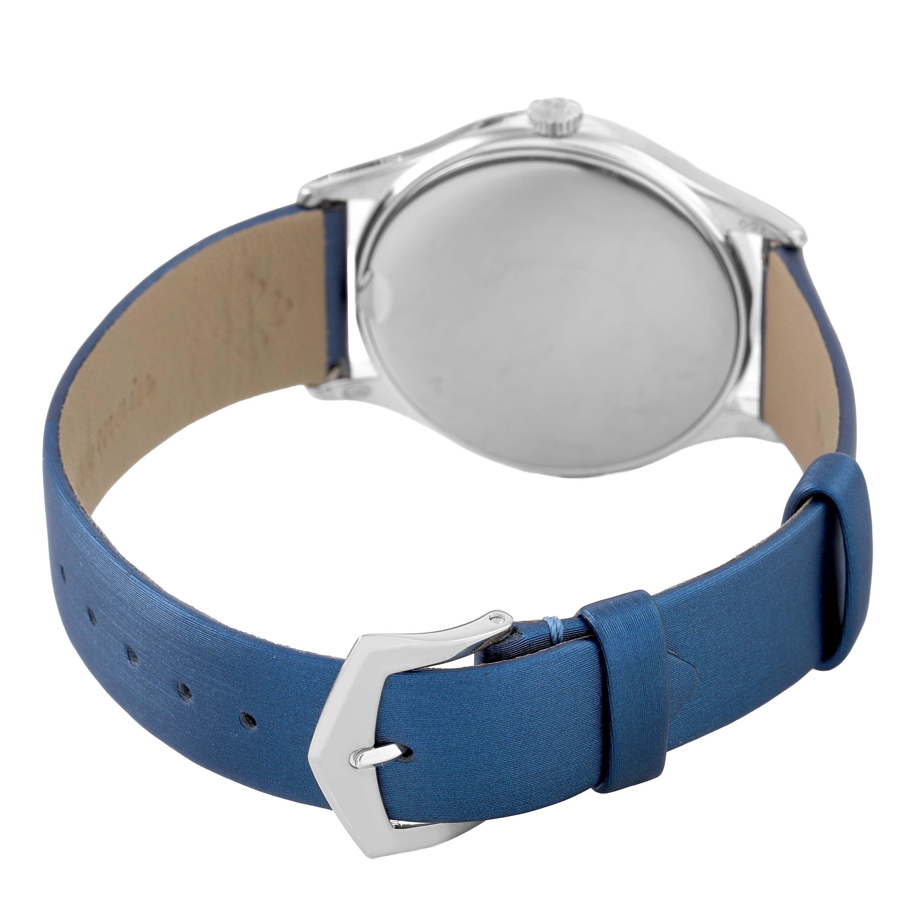 The Patek Philippe Calatrava 4896G Women's White Gold Blue Dial watch is shown from the back, highlighting the case back, crown, and blue leather strap with buckle.
