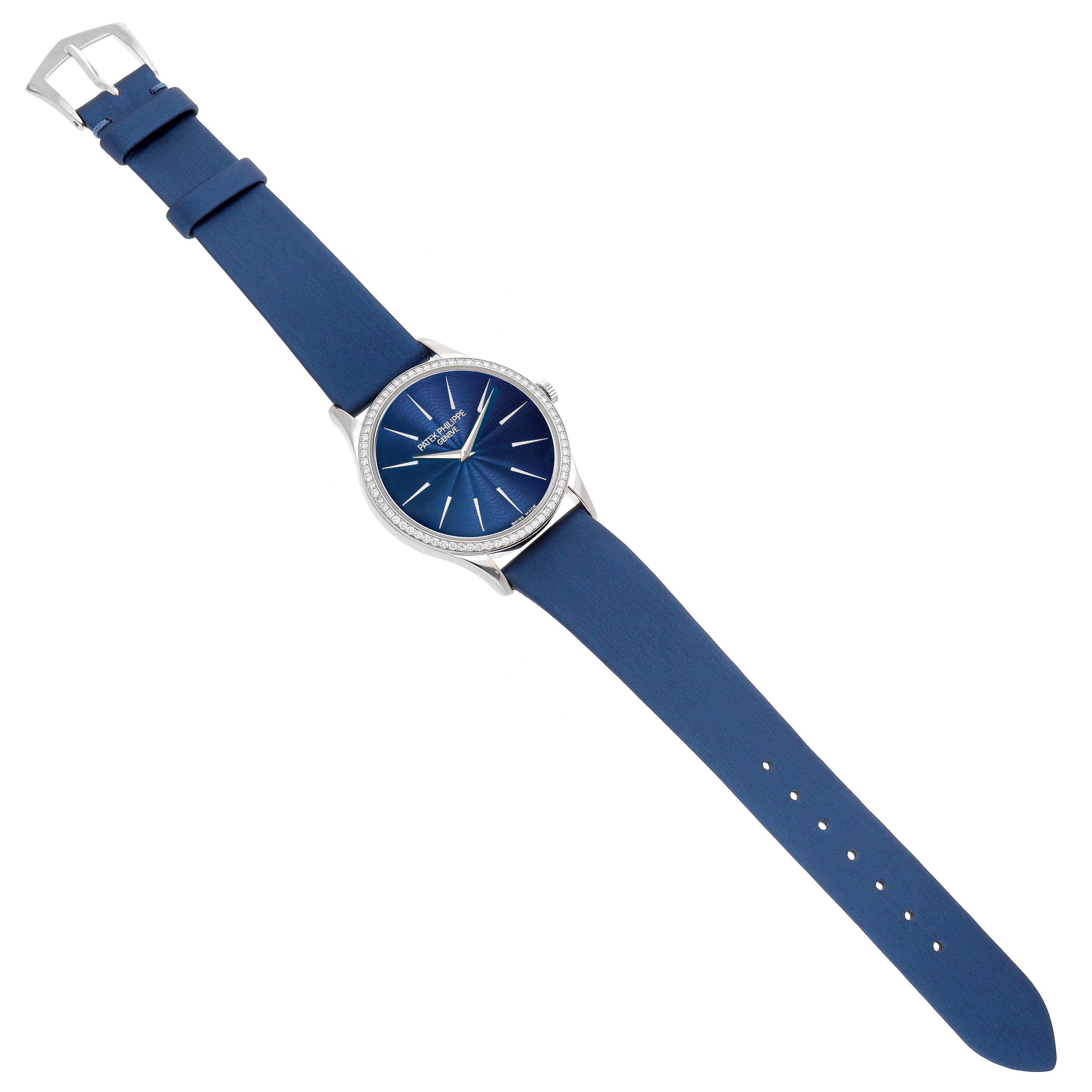 The Patek Philippe Calatrava 4896G Women's White Gold Blue Dial watch is shown from a top-down angle, featuring a blue dial and strap with a silver case.