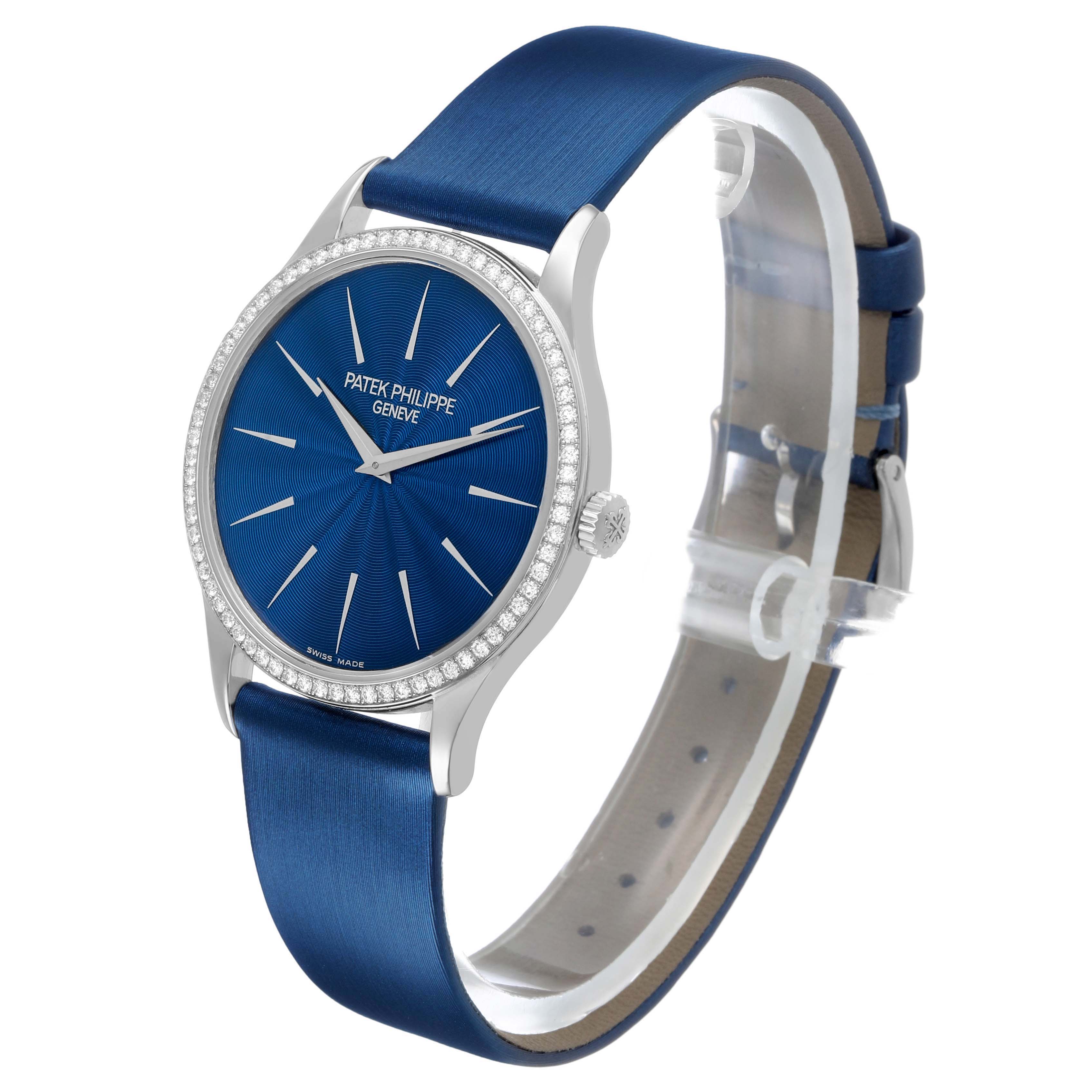 The Patek Philippe Calatrava 4896G Women's White Gold Blue Dial watch is shown at a three-quarter angle, highlighting the blue dial, bezel, and leather strap.