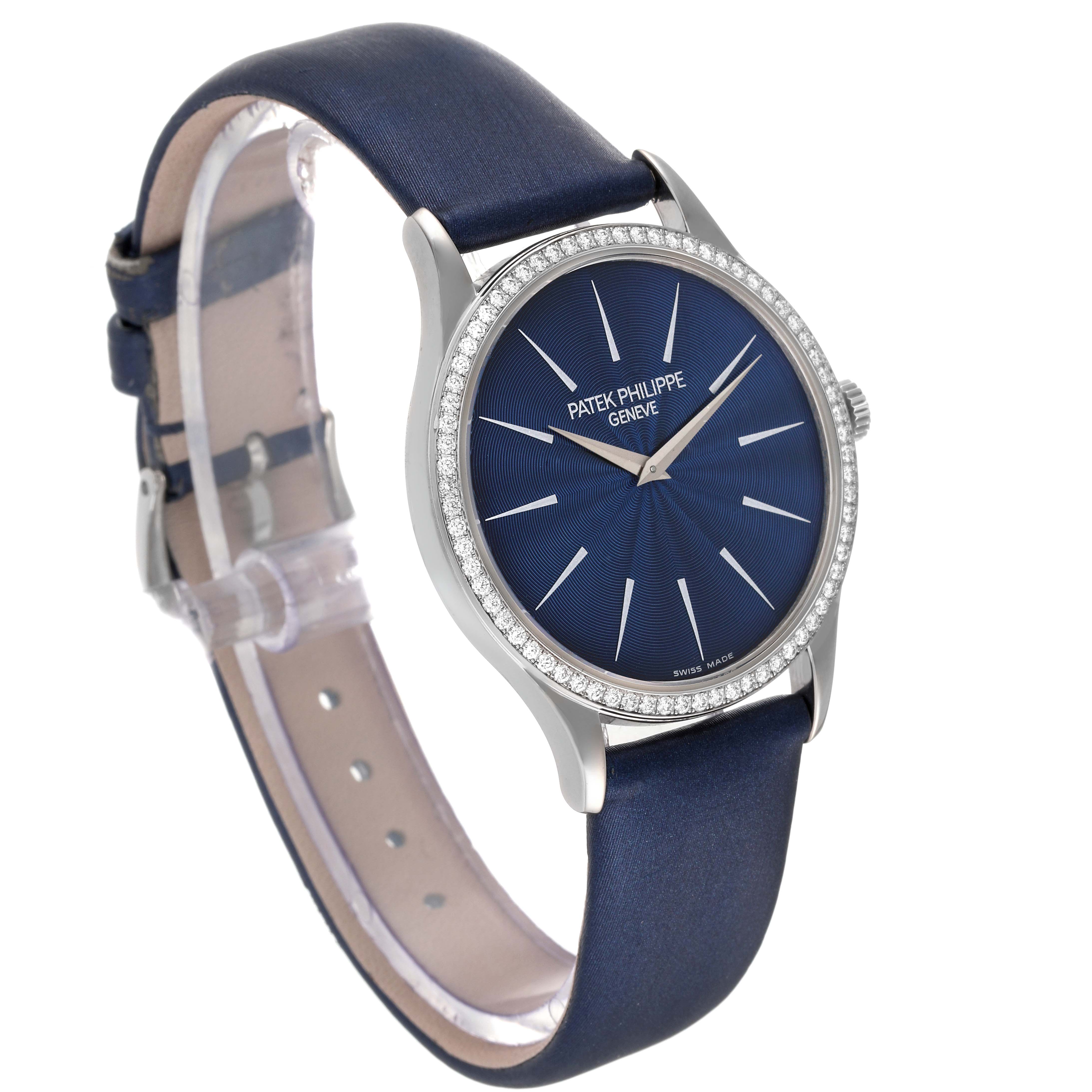 This image shows a side-front angle of the Patek Philippe Calatrava 4896G Women's White Gold Blue Dial 4896G Women's White Gold Blue Dial watch, highlighting its blue dial, diamond bezel, and blue leather strap.