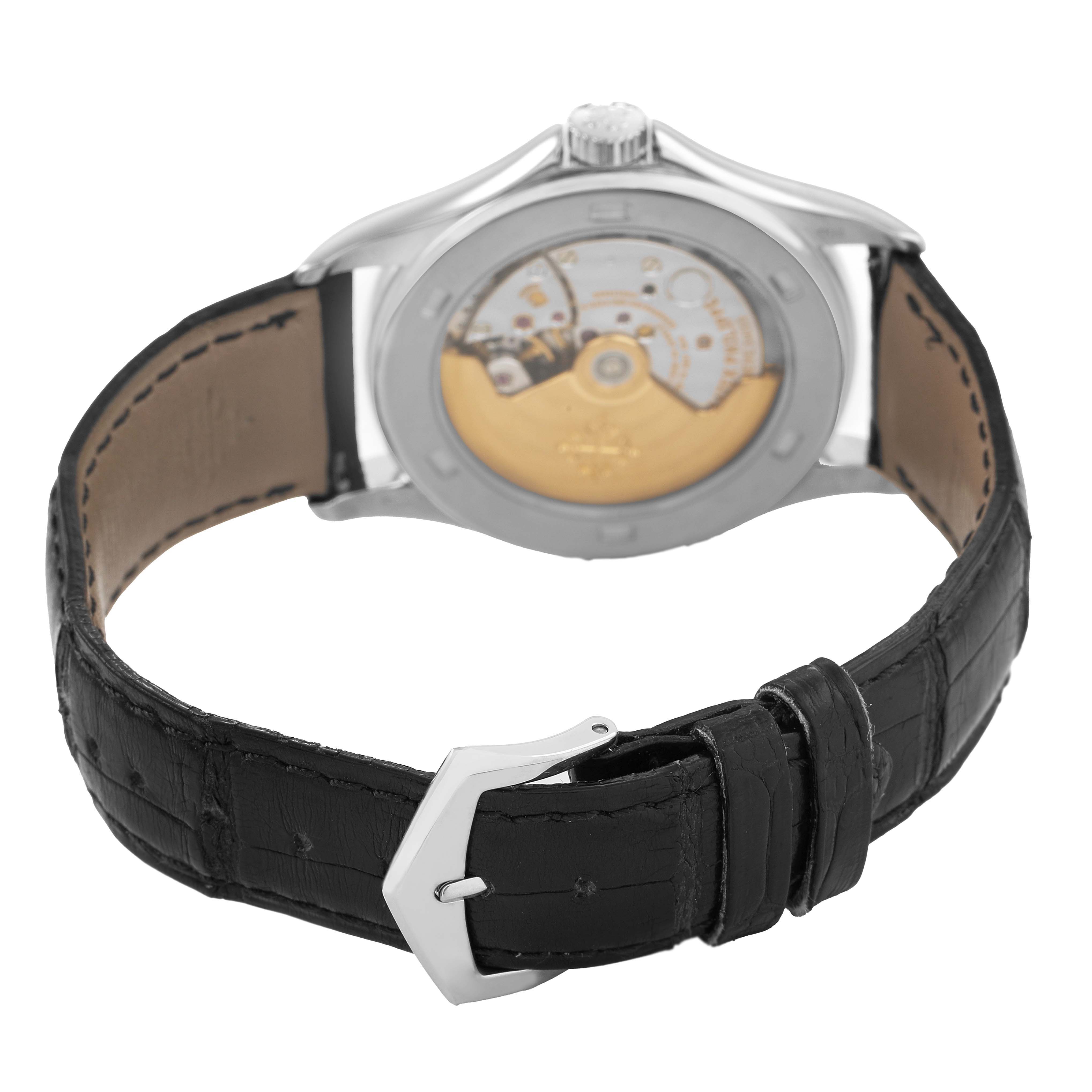 The image shows the Patek Philippe Calatrava 5127G-001 Men's White Gold White Dial watch from the back, highlighting the movement and leather strap with buckle.