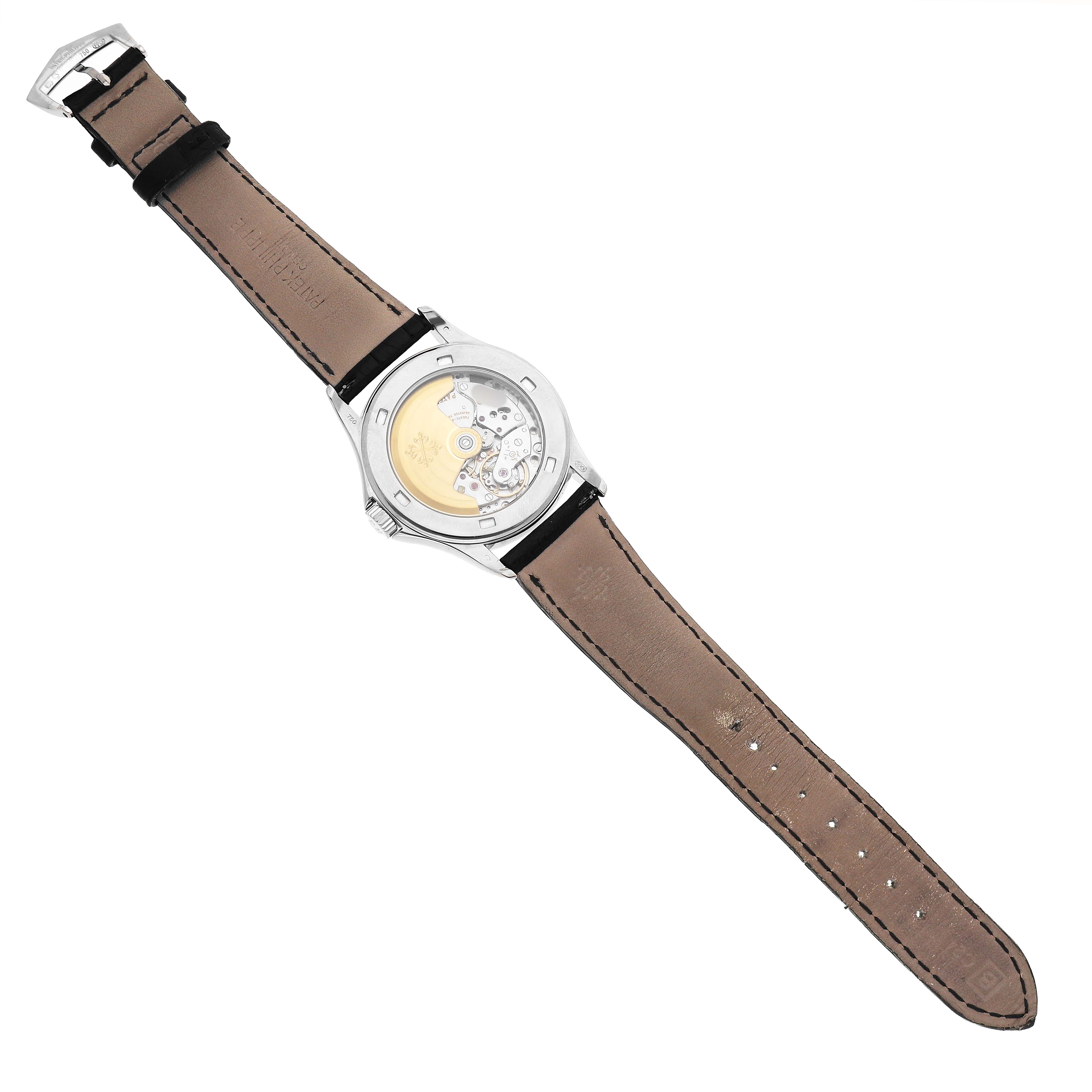 The image shows the back view of the Patek Philippe Calatrava 5127G-001 Men's White Gold White Dial, highlighting the exposed movement and leather strap.