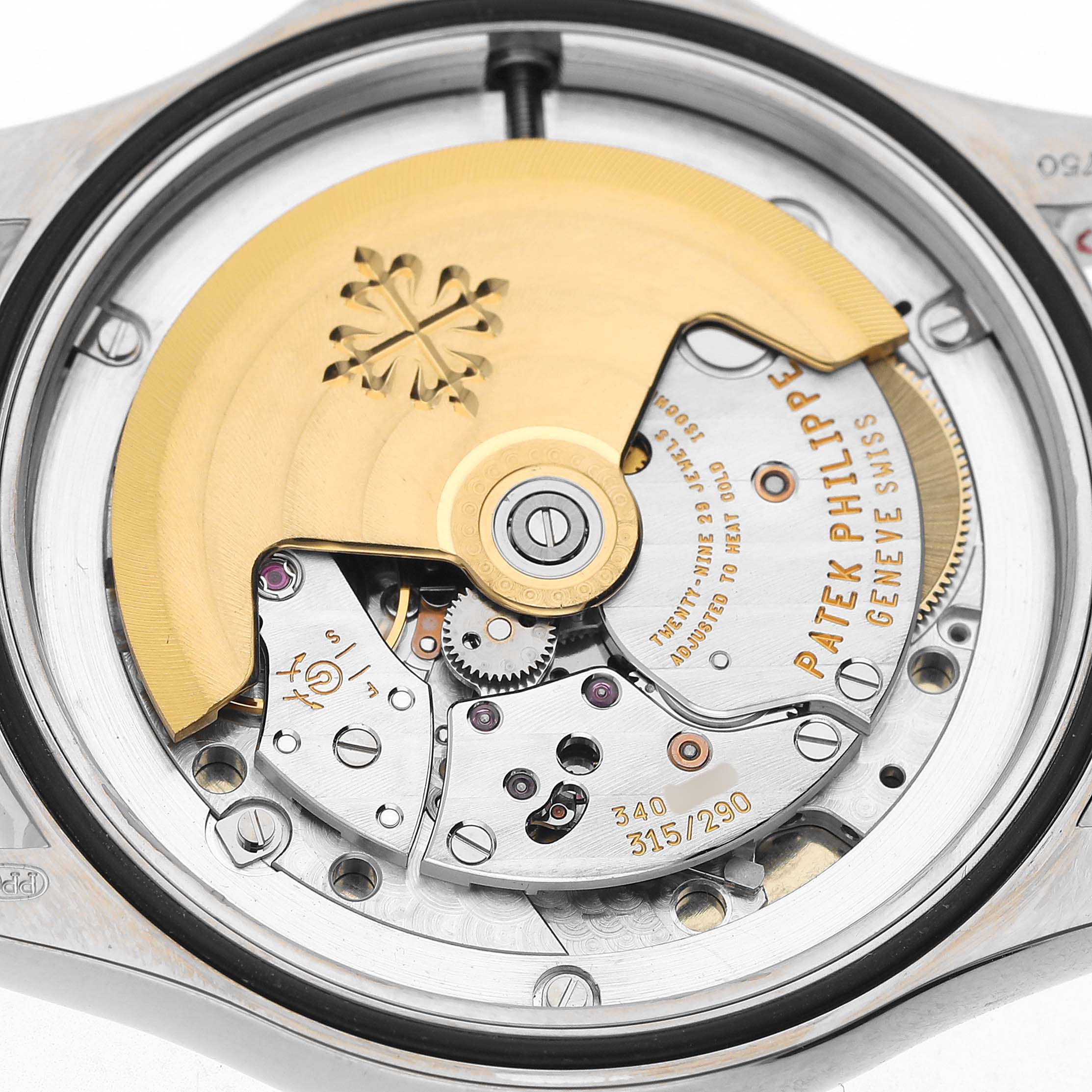 The image shows a close-up of the movement and rotor of a Patek Philippe Calatrava 5127G-001 Men's White Gold White Dial watch.