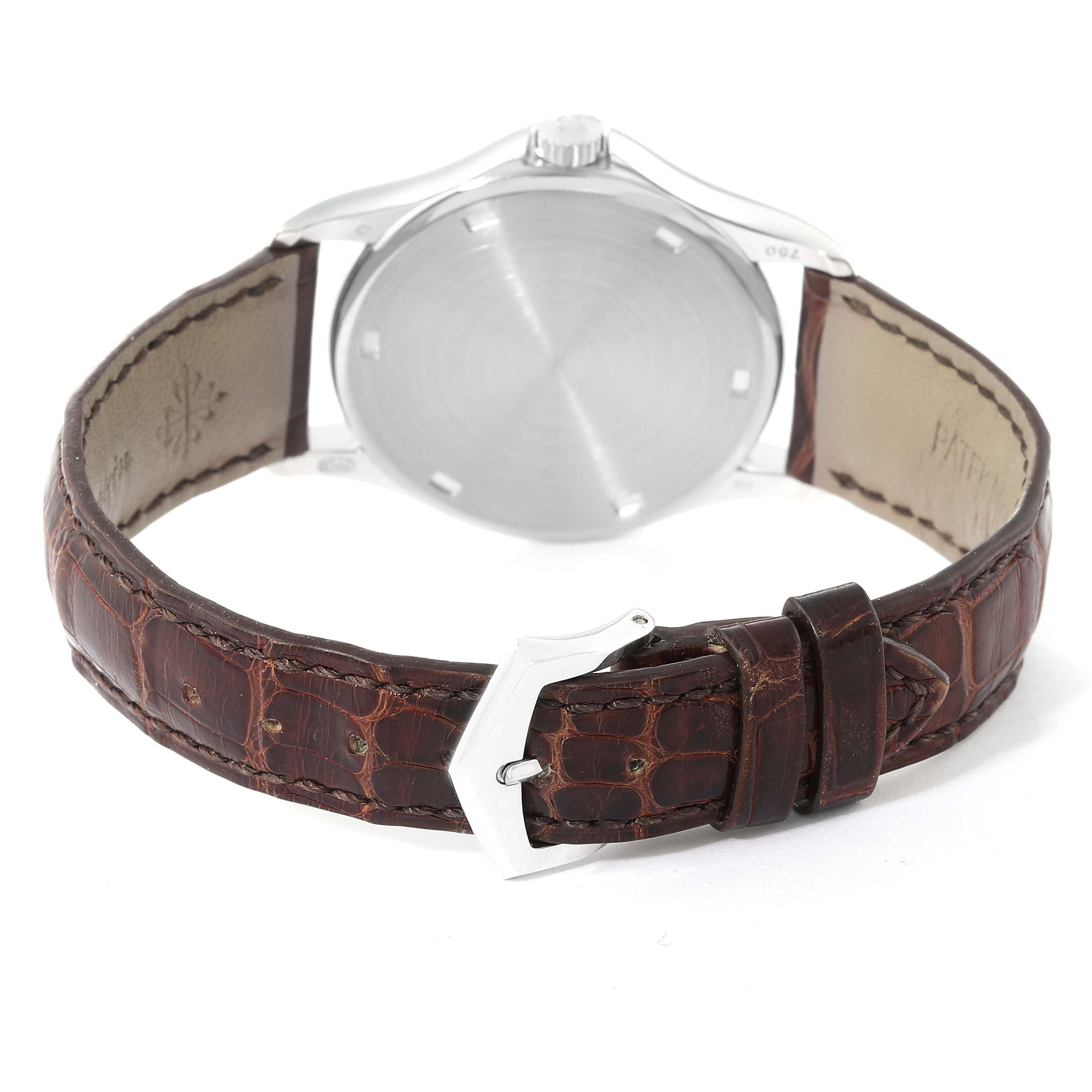 The image shows the back view of a Patek Philippe Calatrava 5115G Men's White Gold White Dial 5115G Men's White Gold White Dial watch, highlighting the case back, leather strap, and buckle.