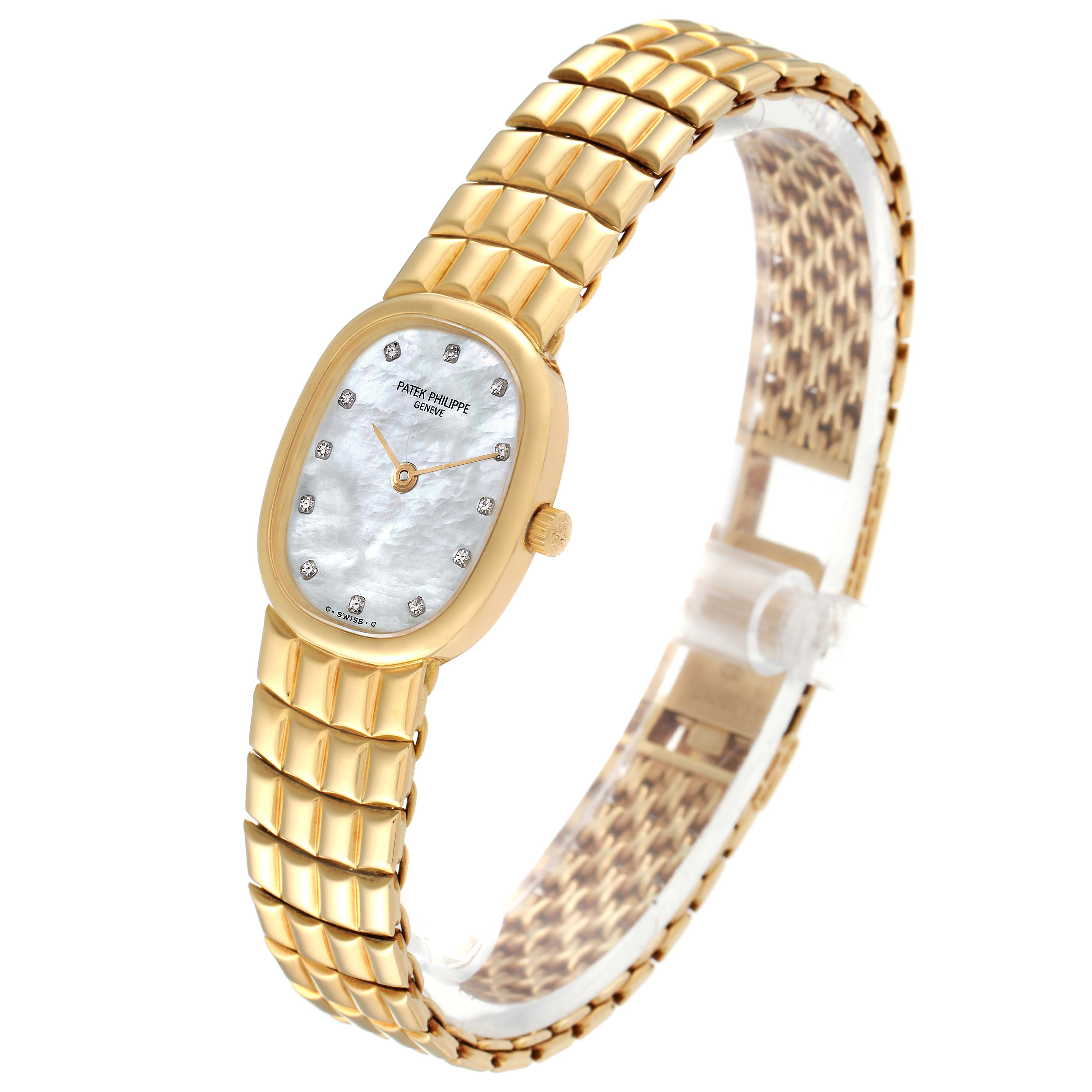 This Patek Philippe Golden Ellipse 4764 Women's Yellow Gold Mother of Pearl Dial 4764 Women's Yellow Gold Mother of Pearl Dial watch is shown at a three-quarter angle, highlighting its gold bracelet, case, and mother-of-pearl dial.