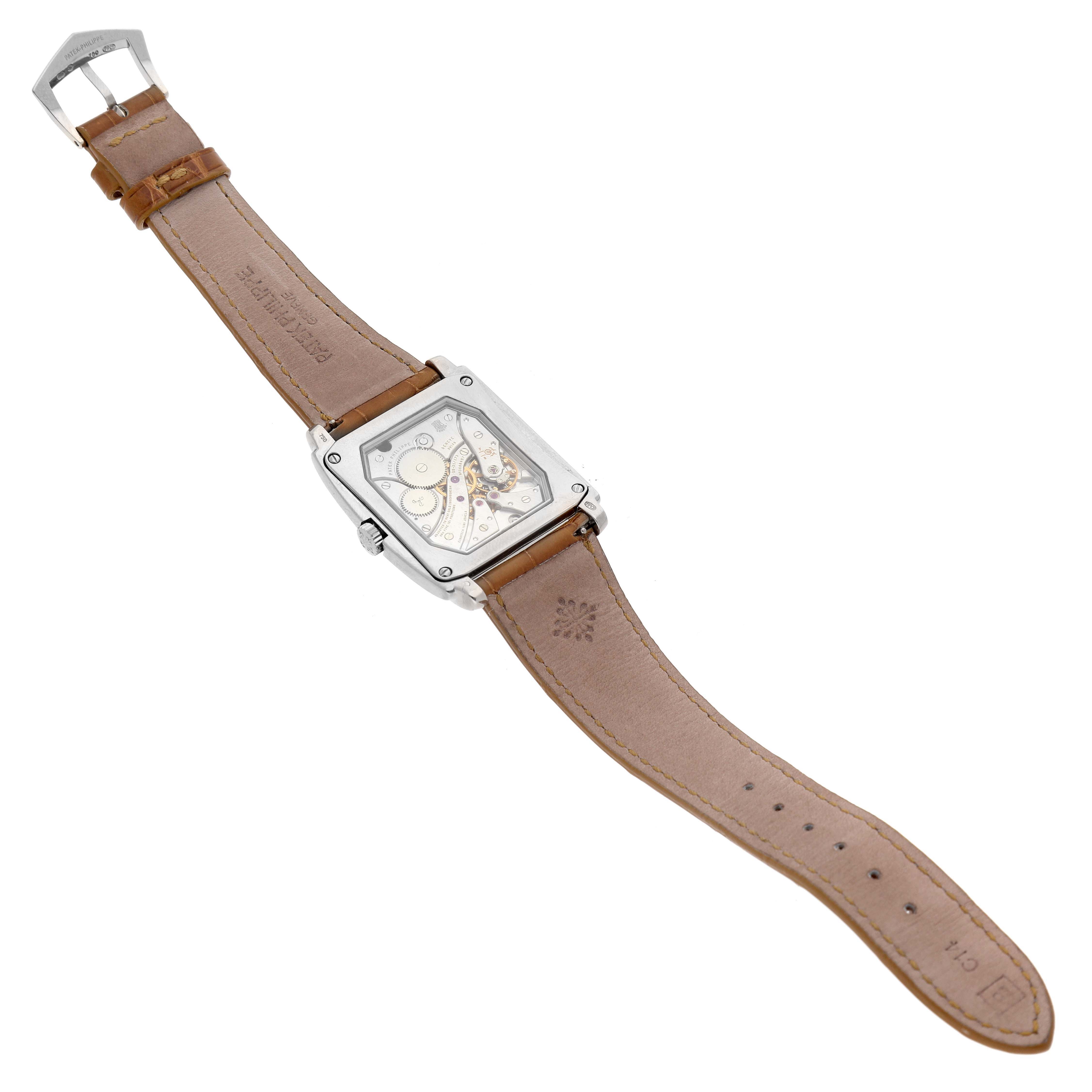 The image shows the back view of a Patek Philippe Gondolo 5124G-001 Men's White Gold Brown Dial 5124G-001 Men's White Gold Brown Dial watch, displaying the mechanical movement and leather strap.