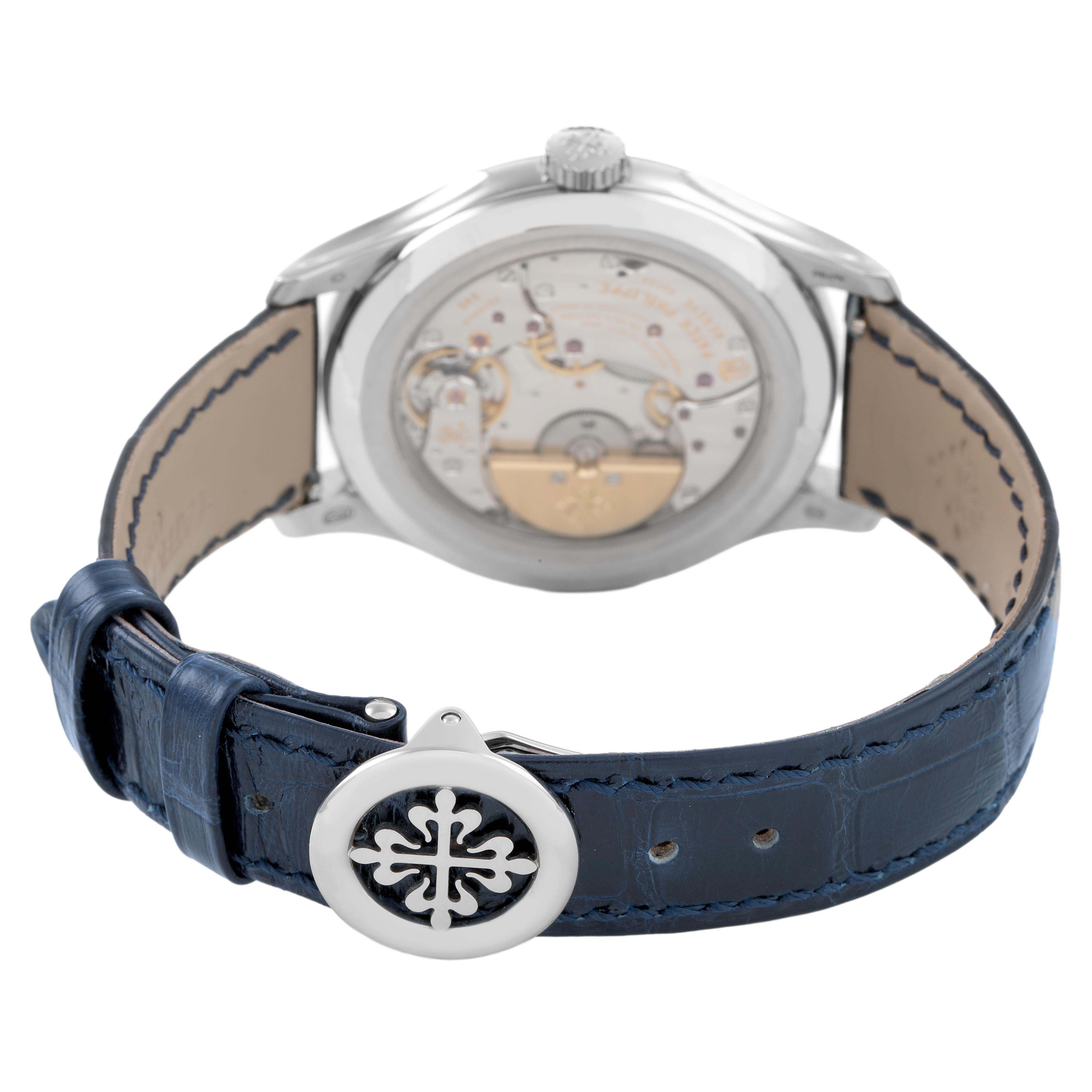 The image shows the back of a Patek Philippe Complications 5327G Men's White Gold Blue Dial watch, highlighting the movement and blue leather strap.