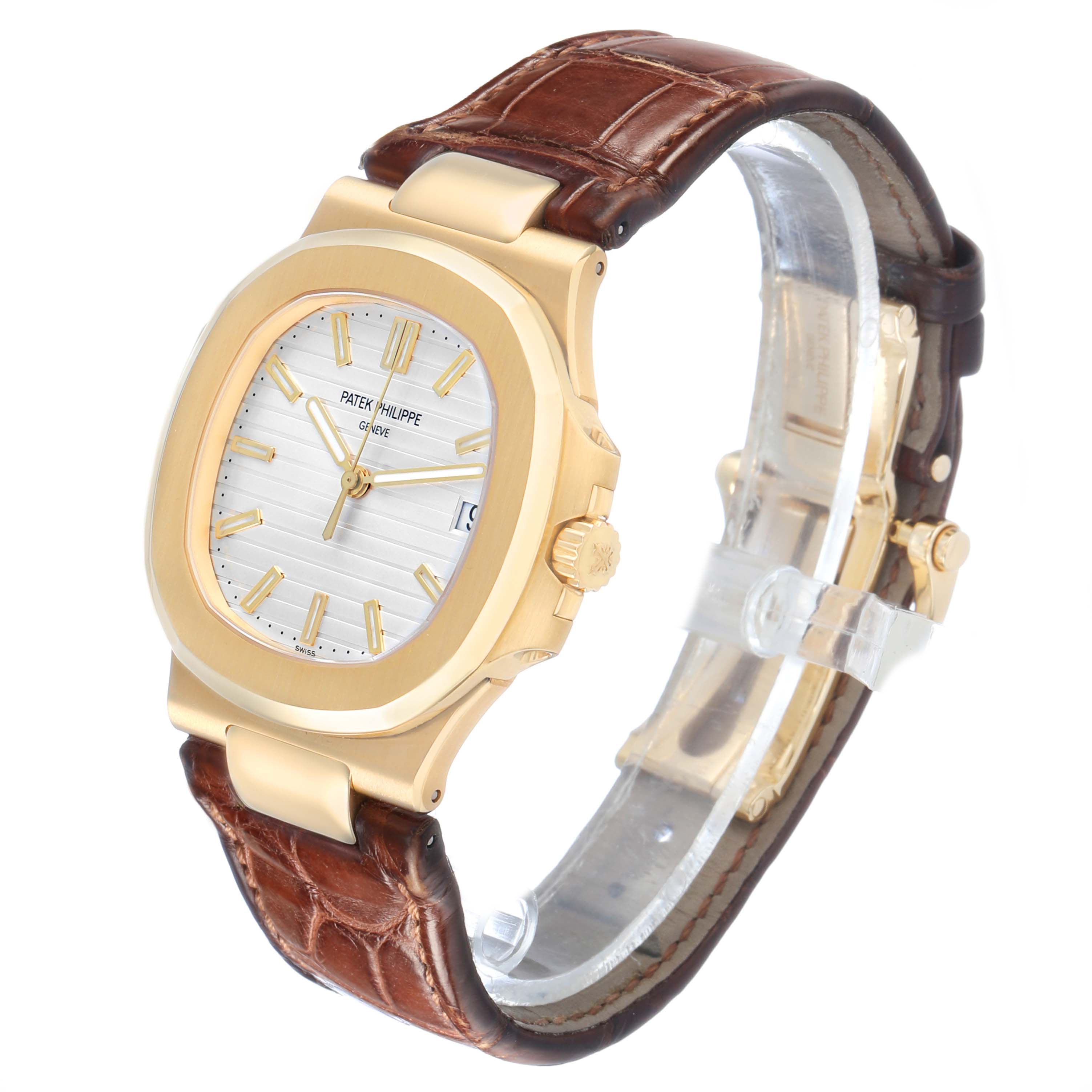 The Patek Philippe Nautilus 5711J Men's Yellow Gold Silver Dial watch is shown from a three-quarter angle, highlighting the face, bezel, and leather strap.