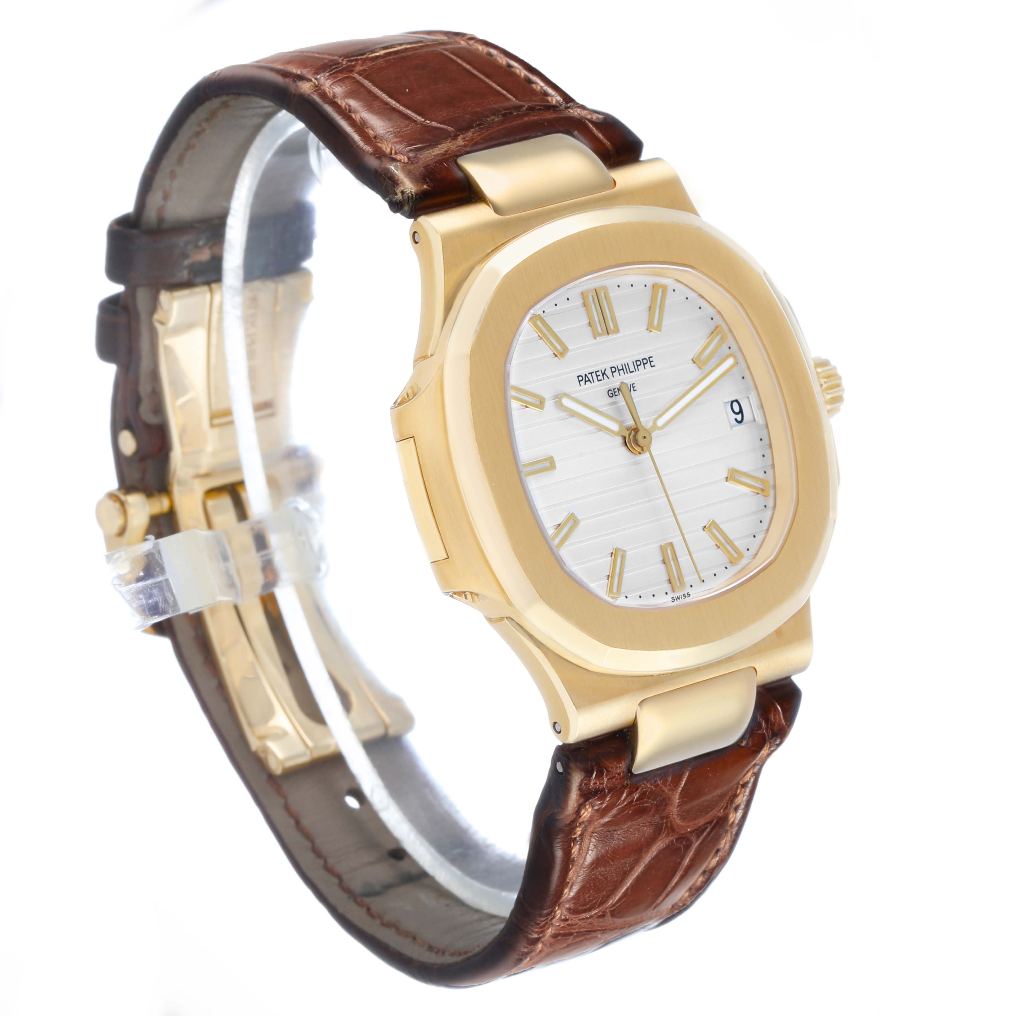 The Patek Philippe Nautilus 5711J Men's Yellow Gold Silver Dial watch is shown at a three-quarter angle, displaying the face, case, and brown leather strap.