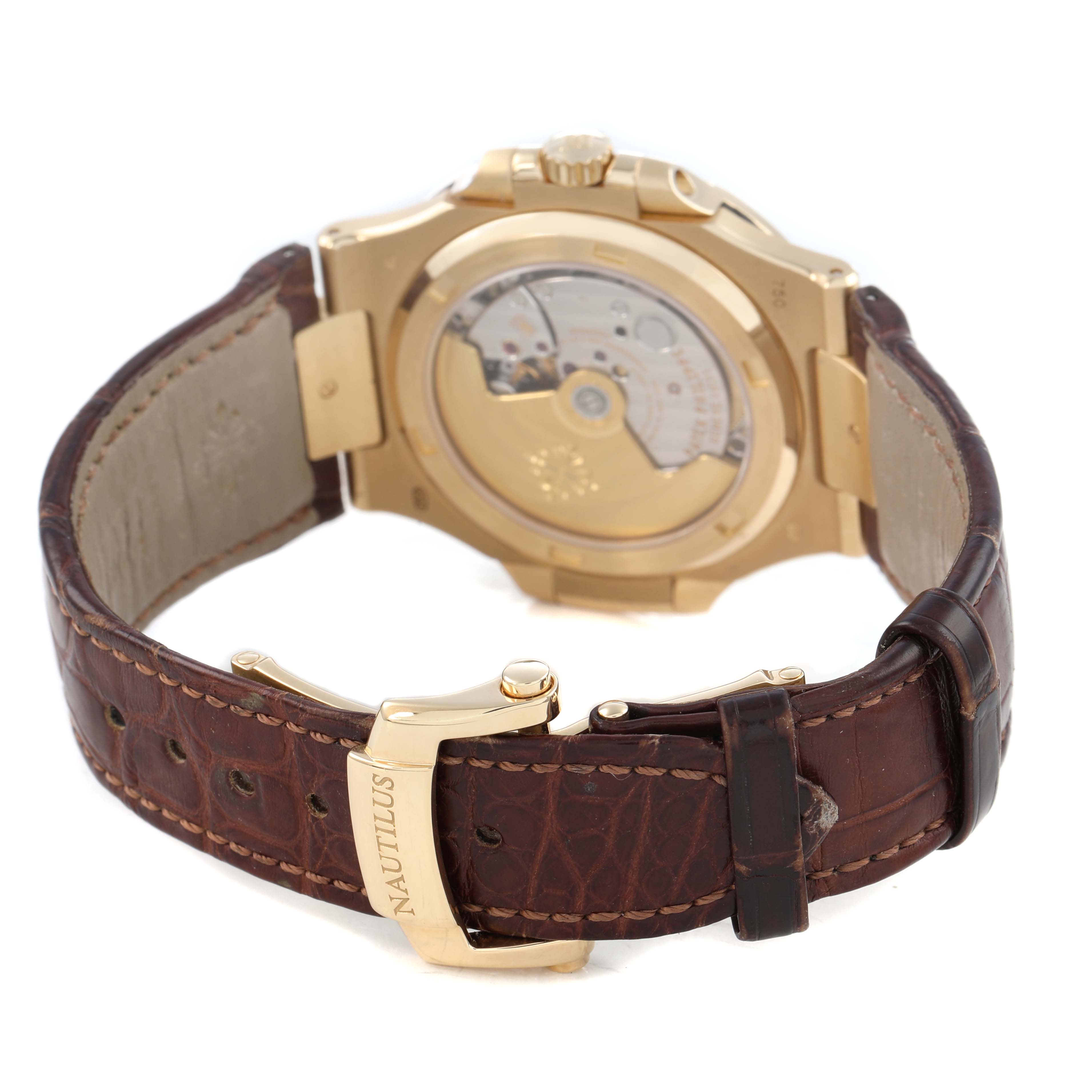 The image shows the back and side of a Patek Philippe Nautilus 5711J Men's Yellow Gold Silver Dial, highlighting the open case back and brown leather strap.