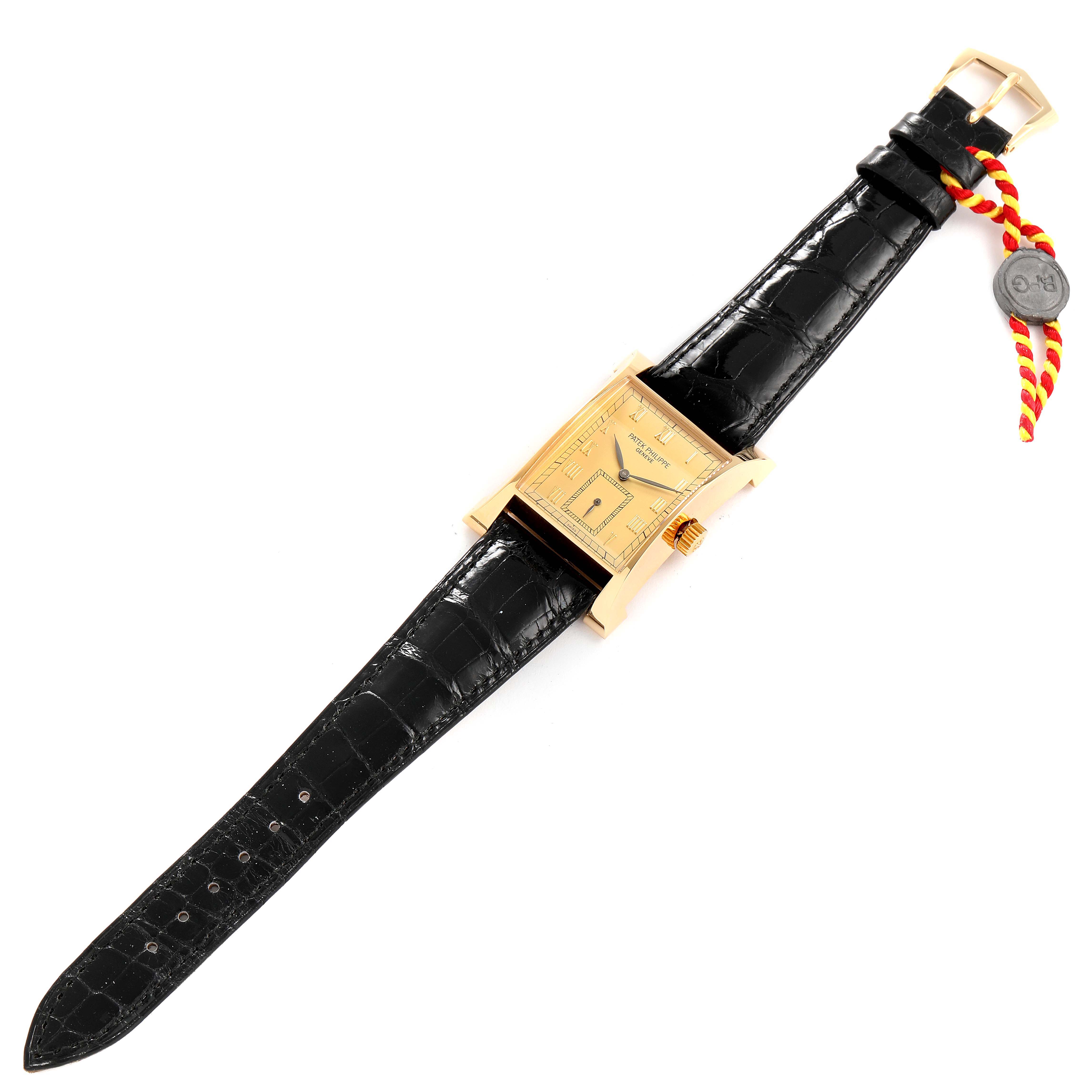 The image shows a Patek Philippe Pagoda 5500 Men's Yellow Gold Champagne Dial 5500 Men's Yellow Gold Champagne Dial Yellow Gold Limited Edition Men's Watch 5500J, featuring a front view with a black leather strap and tag.