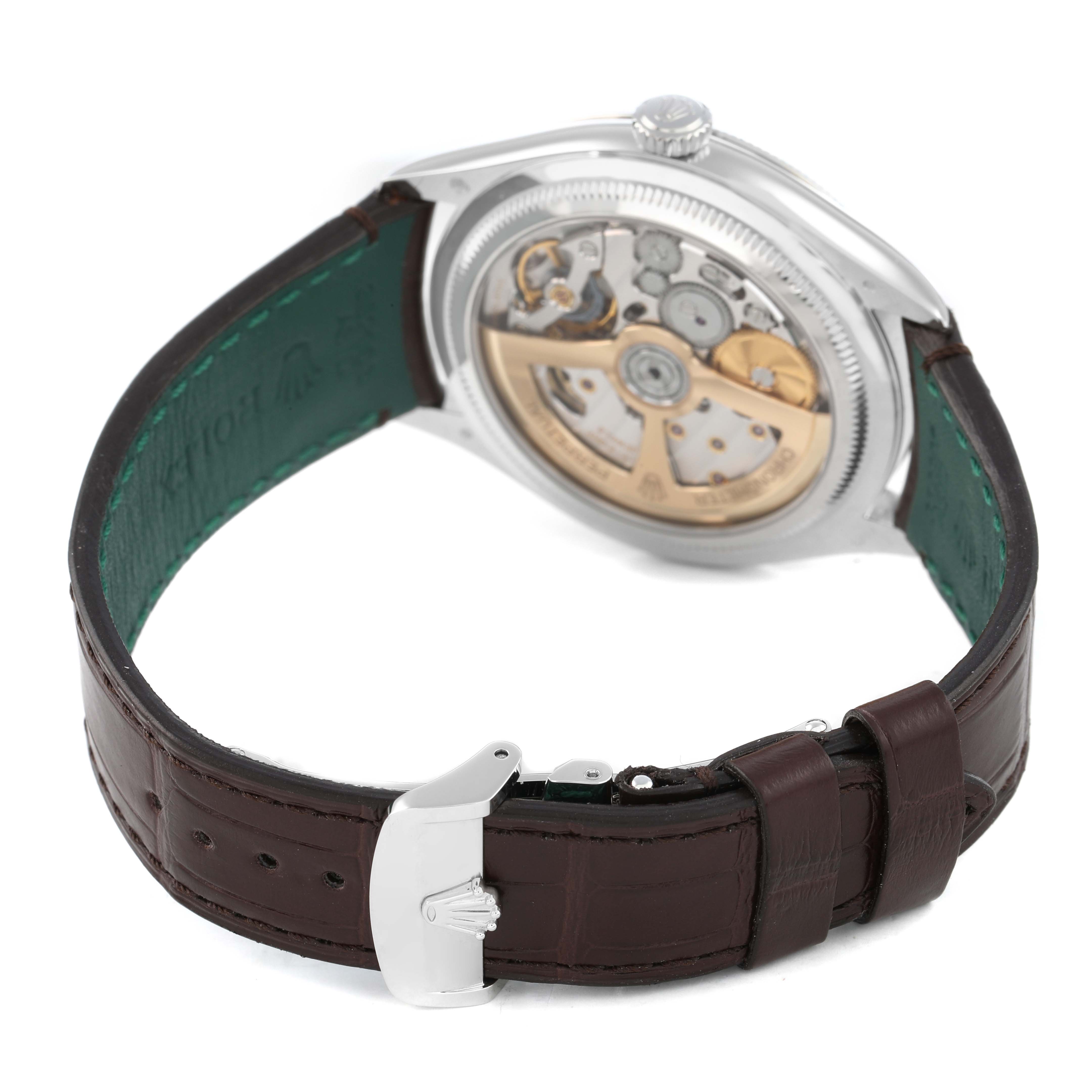The image shows a Rolex 1908 52506 Men's Platinum Blue Dial model watch from a rear angle, highlighting its movement and open leather strap.