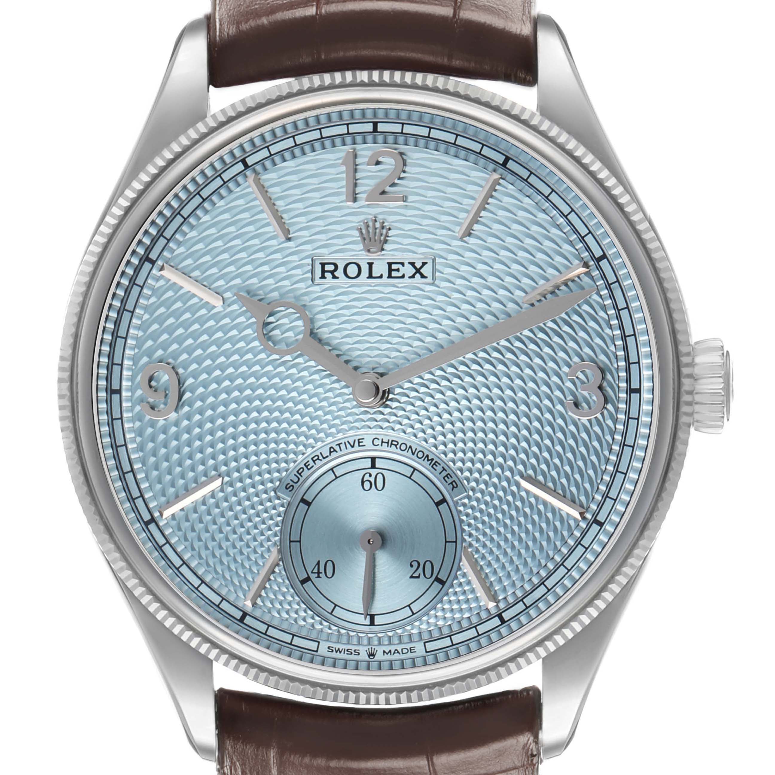 The Rolex 1908 52506 Men's Platinum Blue Dial model is shown from a front angle, featuring a textured dial, numeral markers, and a leather strap.