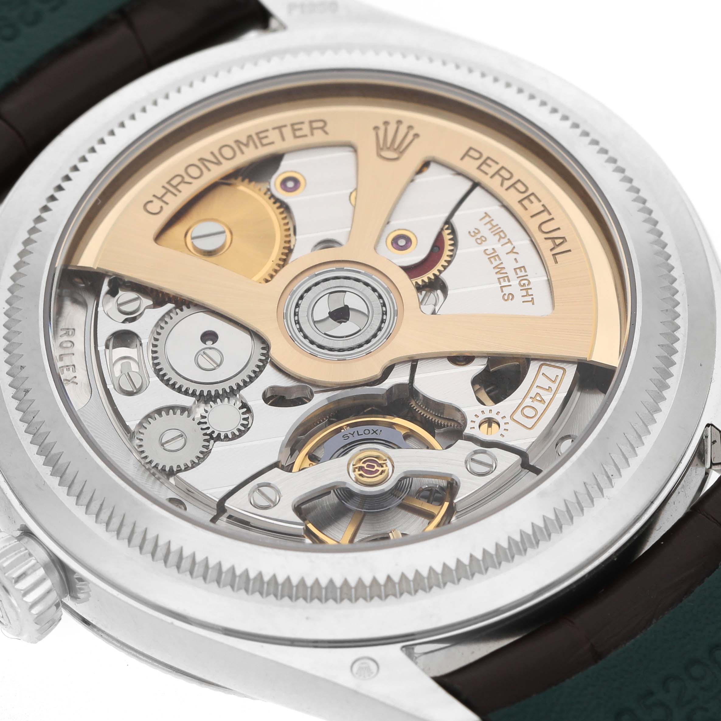 The image shows the back view of the Rolex 1908 52506 Men's Platinum Blue Dial model, highlighting its intricate movement and gears.