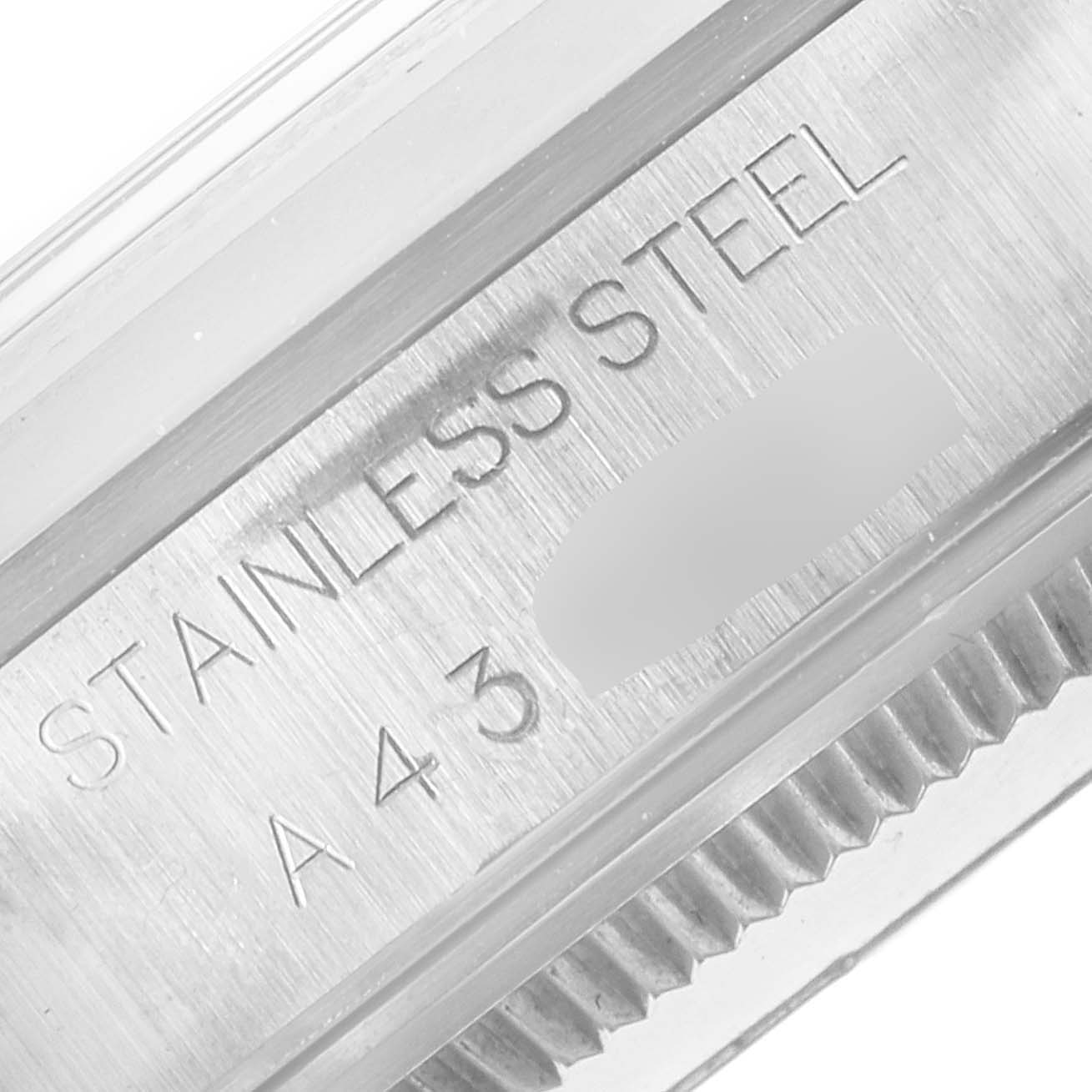 This close-up shot shows the side of the stainless steel case of a Rolex Air-King 14000 Men's Stainless Steel Blue Dial 14000 Men's Stainless Steel Blue Dial watch with visible engraving.